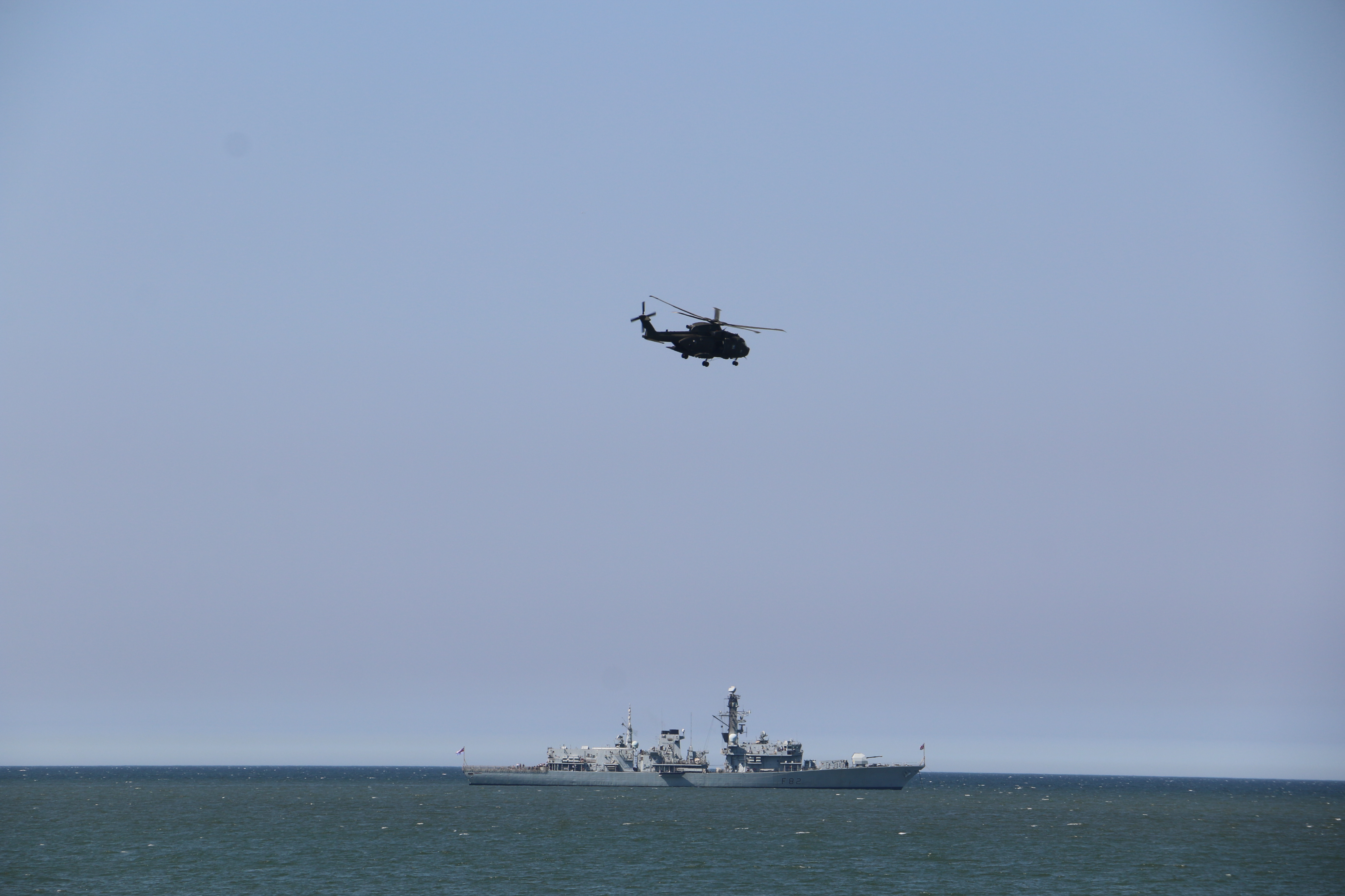 HMS Somerset and Merlin Helicopter in Llandudno Bay