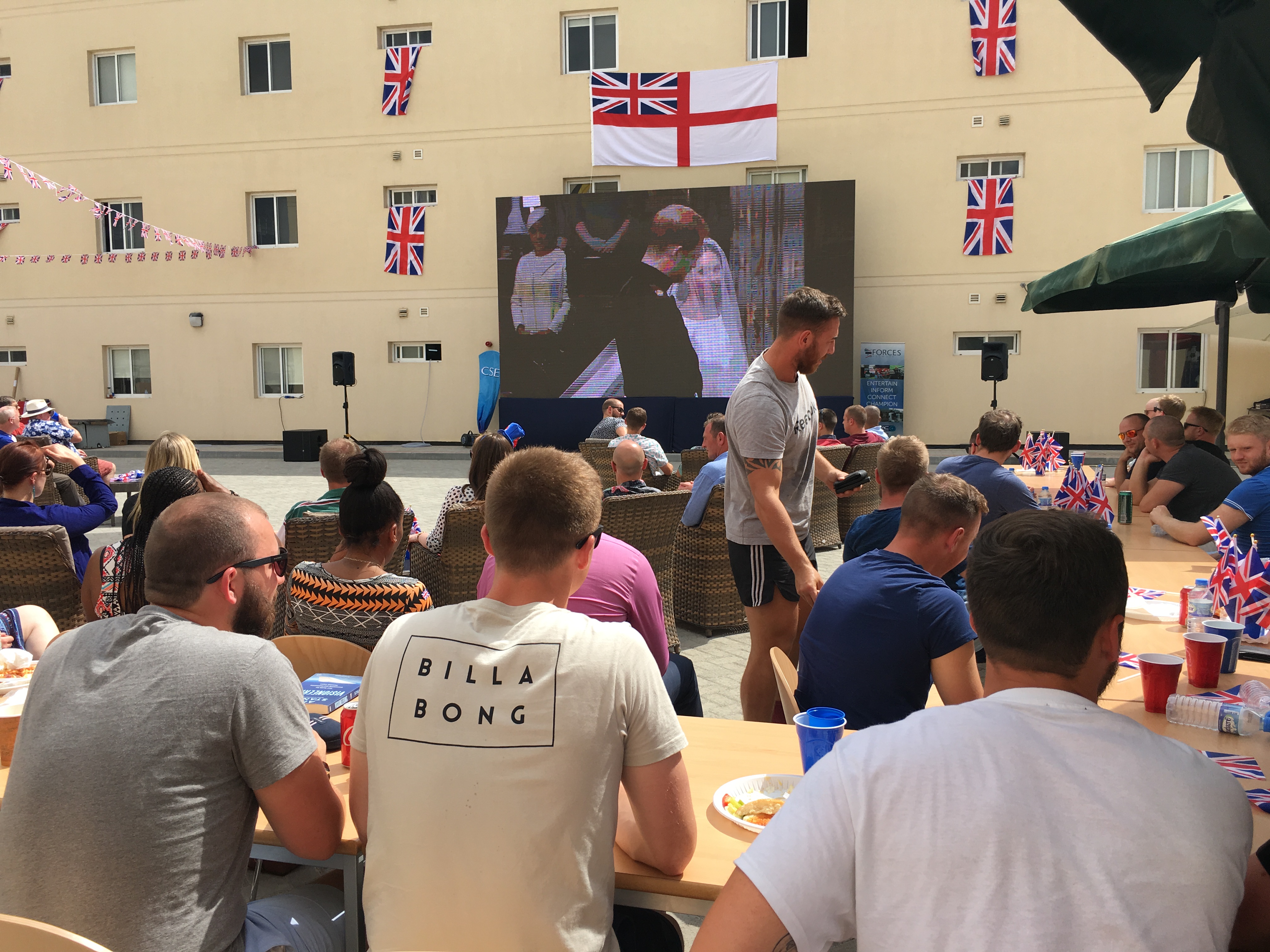 Serving personnel in Bahrain watching the Royal wedding on a CSE big screen