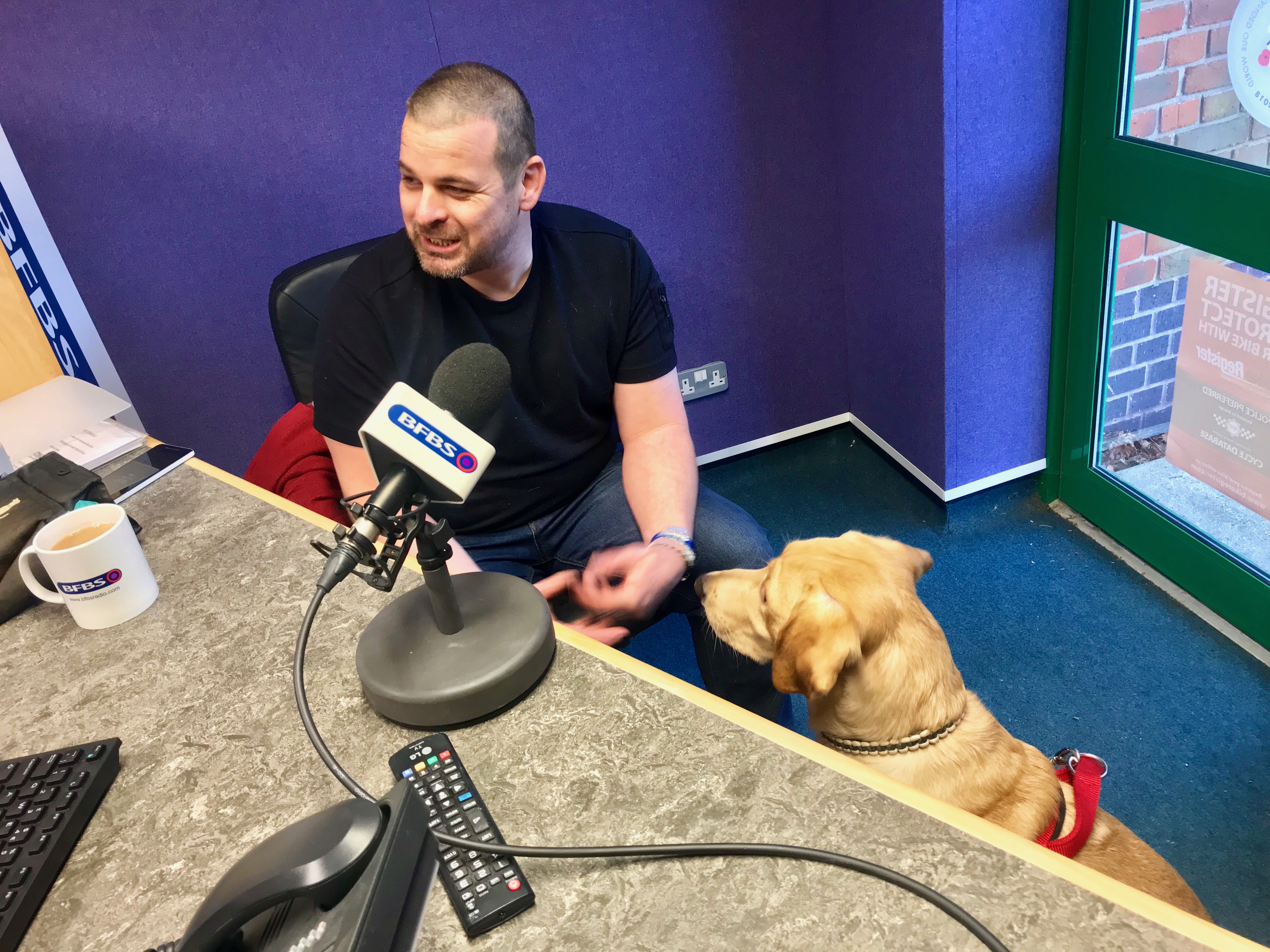 Veteran Blake Clark and his PTSD support dog being interviewed at BFBS