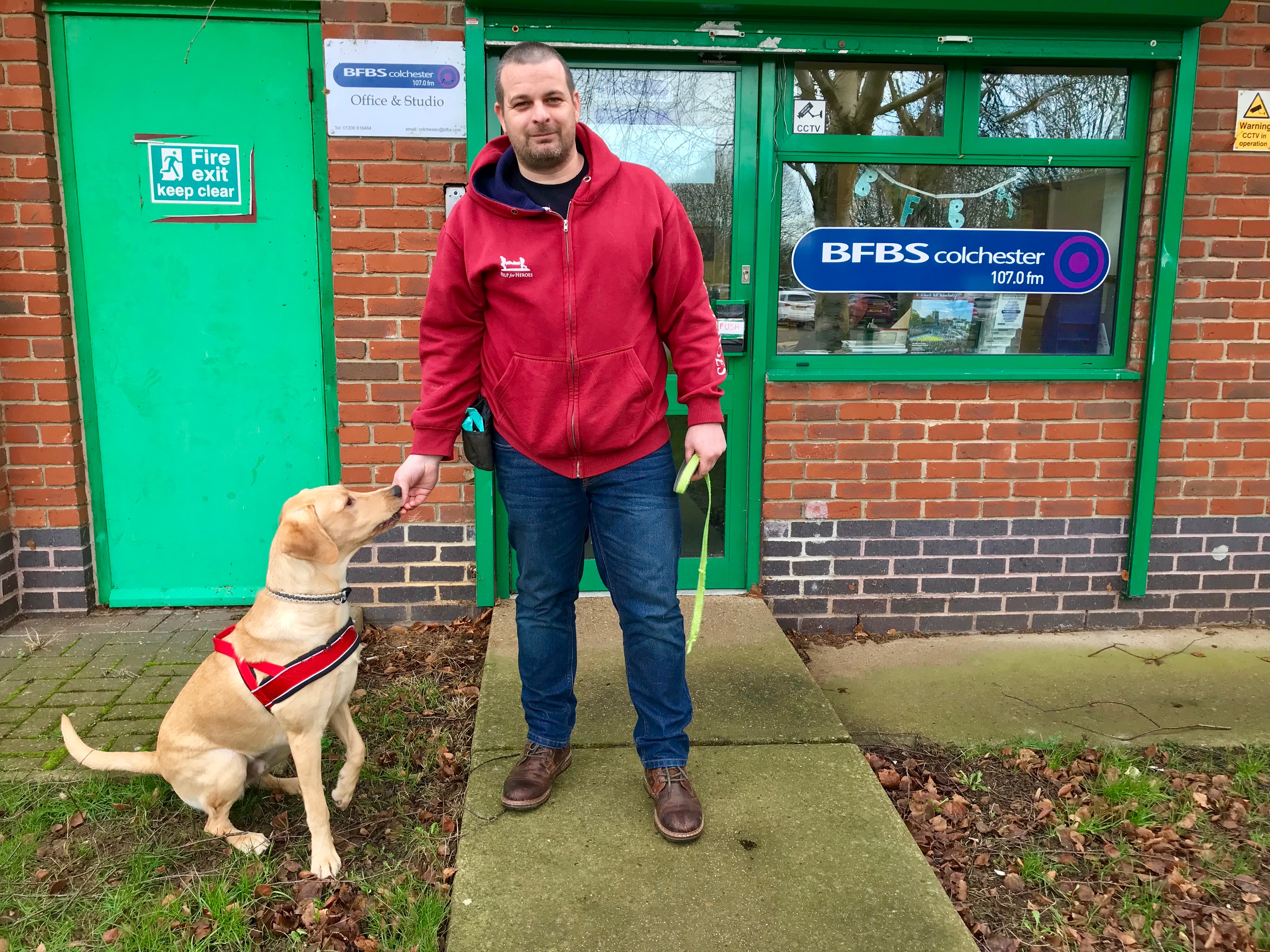 Veteran Blake Clark and his support dog Odin outside BFBS