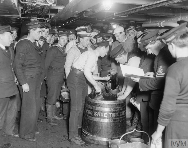 Royal Navy sailors receiving their daily 'tot' of dark rum (Picture: IWM).