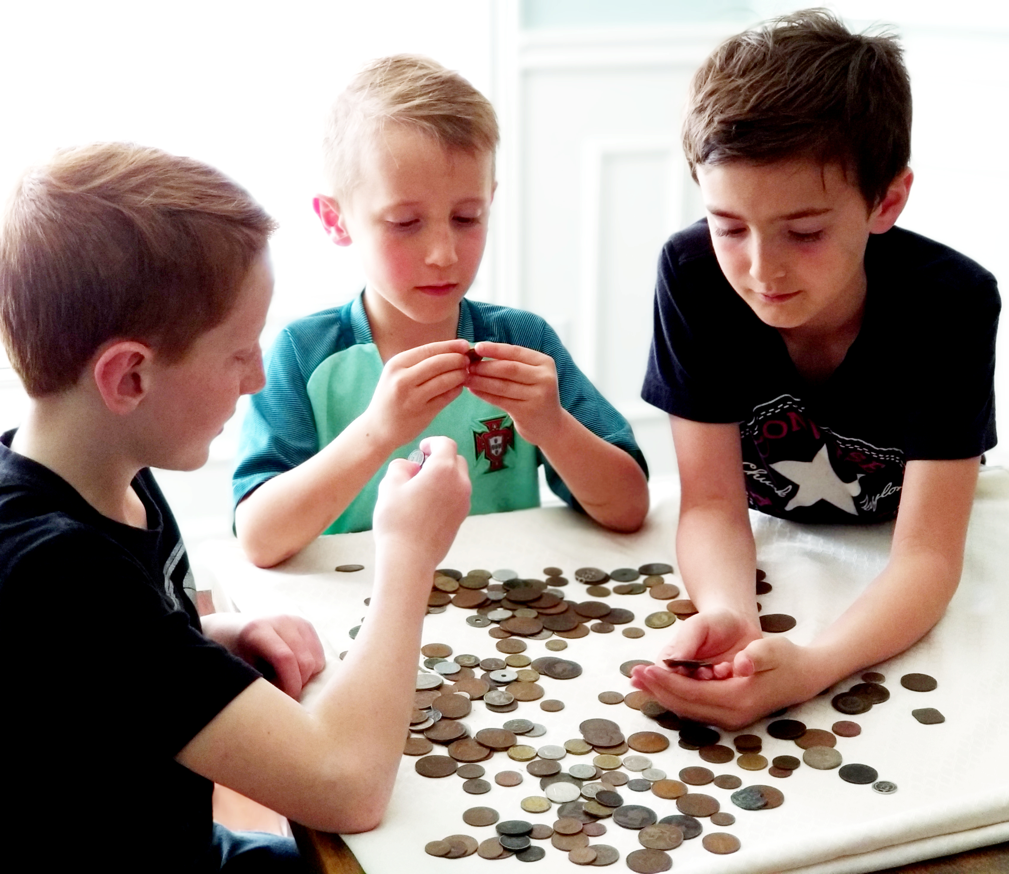 Mr Iacovelli's three sons with his coin collection