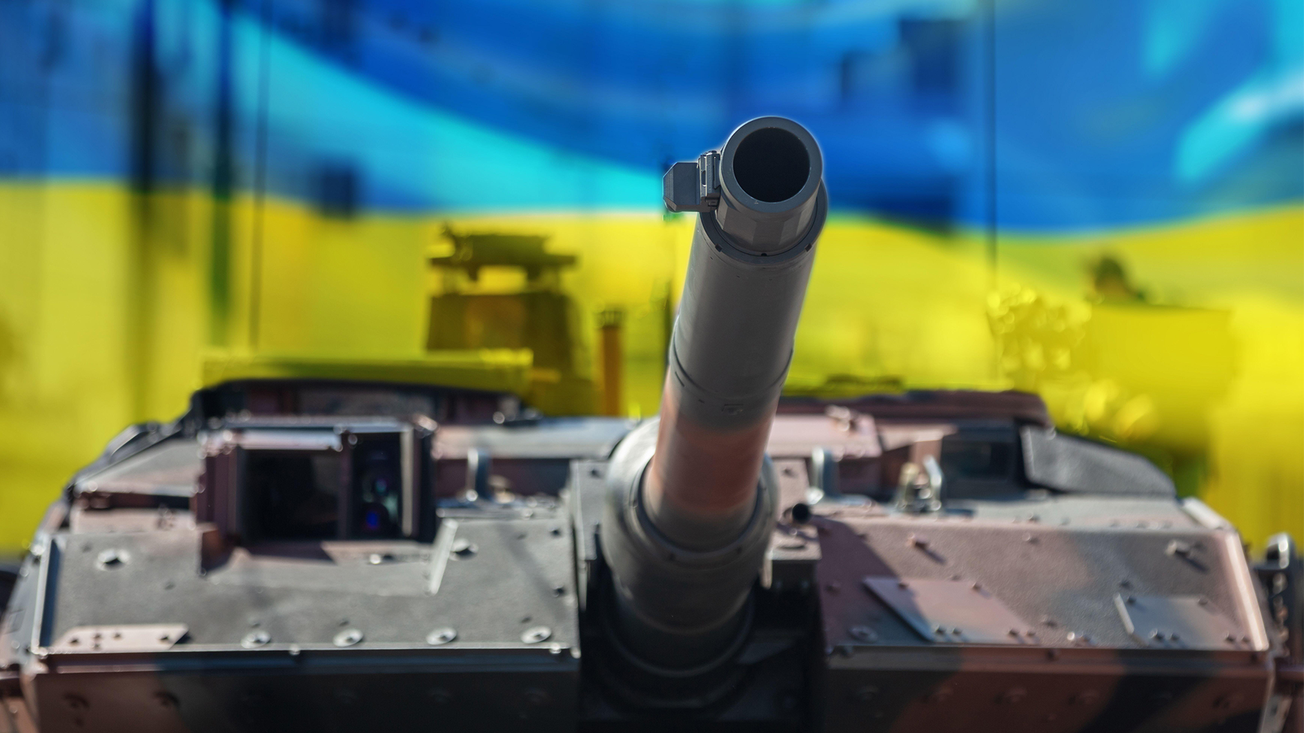 Image ID: 2J25TC1 Leopard main battle tank, Ukraine flag background. Military heavy vehicle, city background. Army equipment for war and defence 190223 CREDIT ALAMY STOCK PHOTO