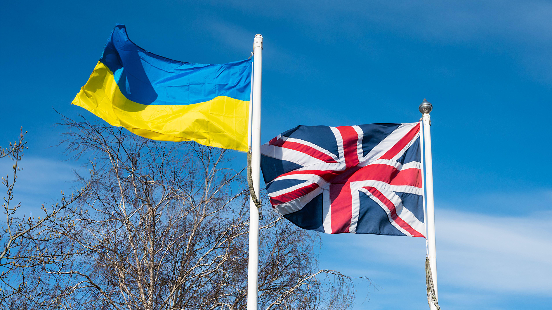 Image ID 2J2N4TG Ukrainian flag and British Union Jack flag flying together in UK, showing solidarity & support for people of Ukraine in the Russia Ukraine war CREDIT ALAMY STOCK PHOTO 270423.png