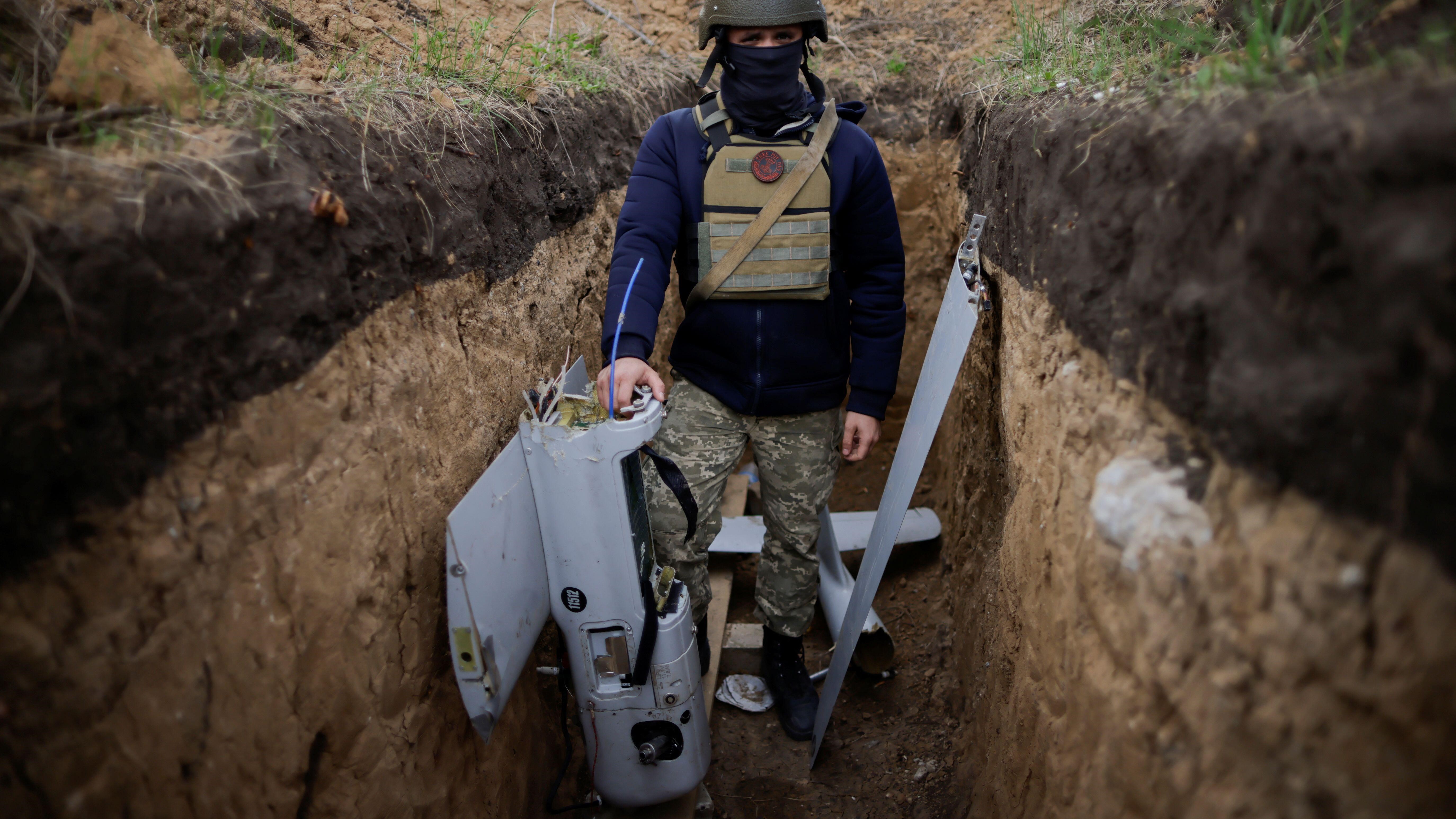 Image ID 2J6A0WE Ukrainian serviceman with a downed 'Russian drone' at military camp, in Zaporizhzhia region 29042022 REUTERS,Alamy Stock Photo.jpg