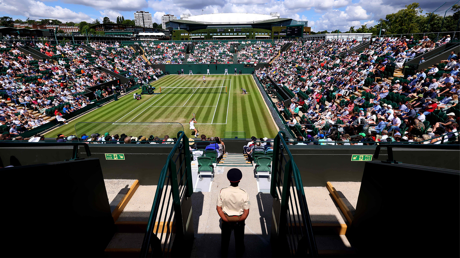 Image ID 2JFGY0P London, UK. London, UK. 3rd July 2022, All England Lawn Tennis and Croquet Club, London, England Wimbledon Tennis tournament A military steward observes a match EXP 030723 CREDIT ALAMY.png