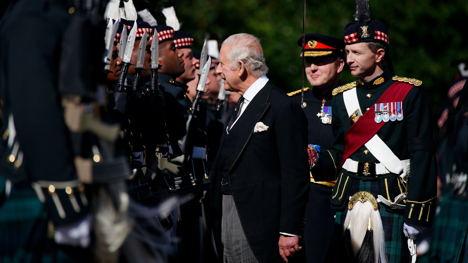 King Charles inspects soldiers from the Royal Regiment of Scotland