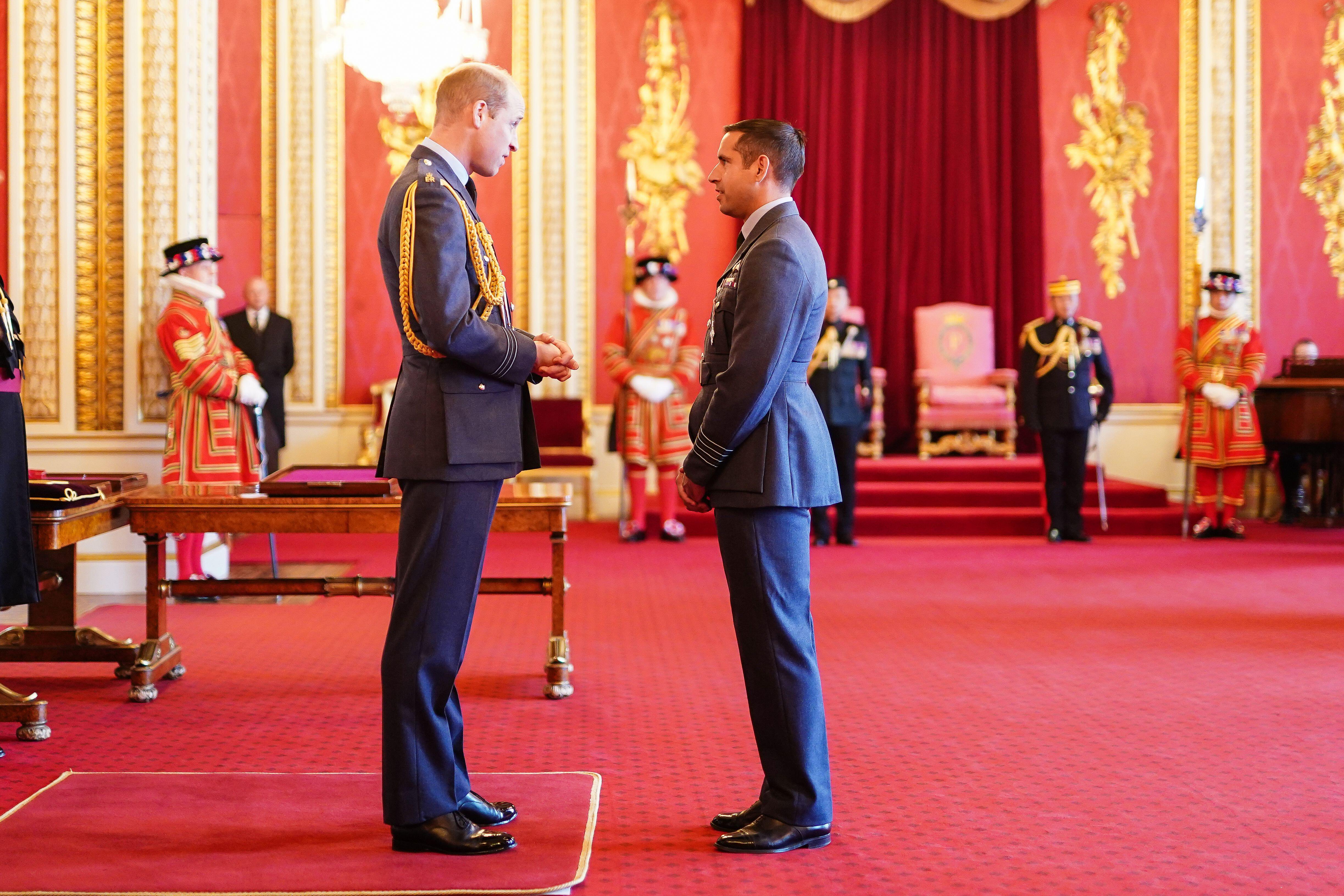 Group Captain Latchman receives the Air Force Cross from the Prince of Wales