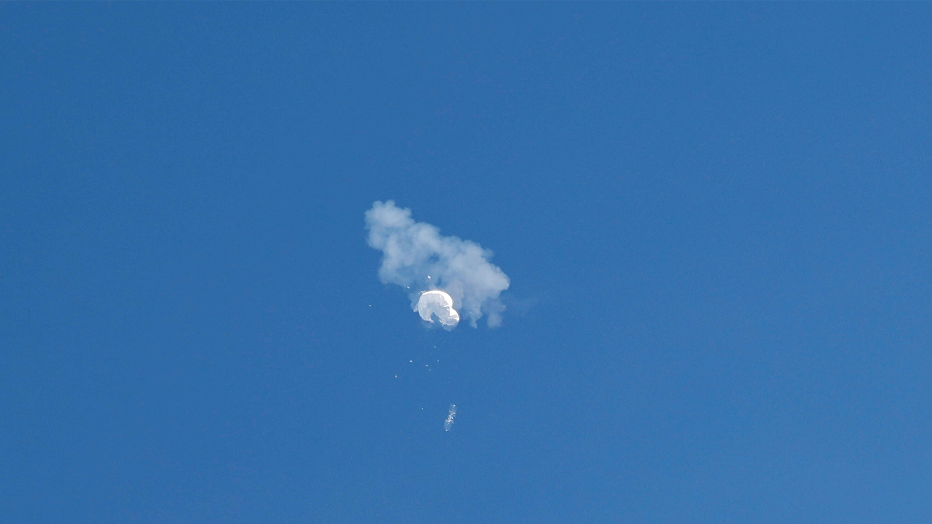 The suspected Chinese spy balloon drifts to the ocean after being shot down off the coast in Surfside Beach, South Carolina