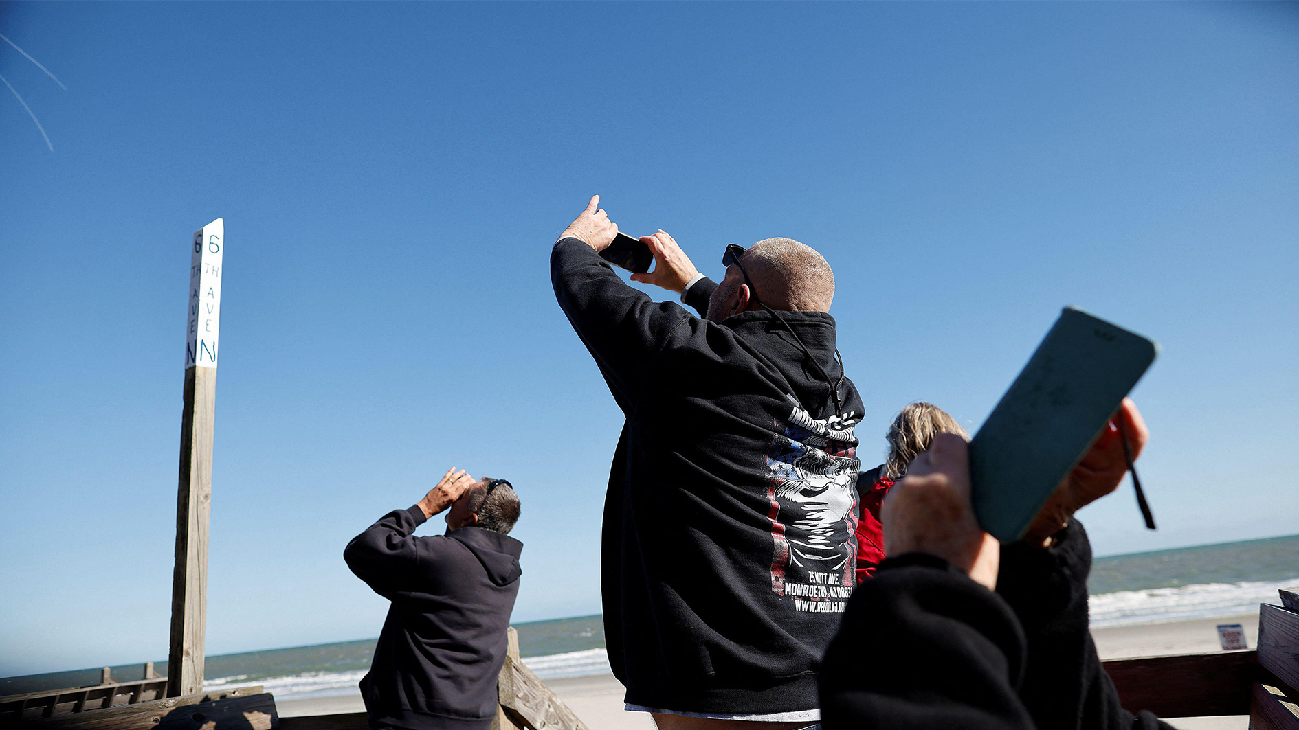 Image ID 2MYCYH1 People photograph a suspected Chinese spy balloon as it floats off the coast in Surfside Beach, South Carolina, U.S. February 4, 2023 CREDIT EXP 070223 REUTERS ALAMY STOCK PHTOT