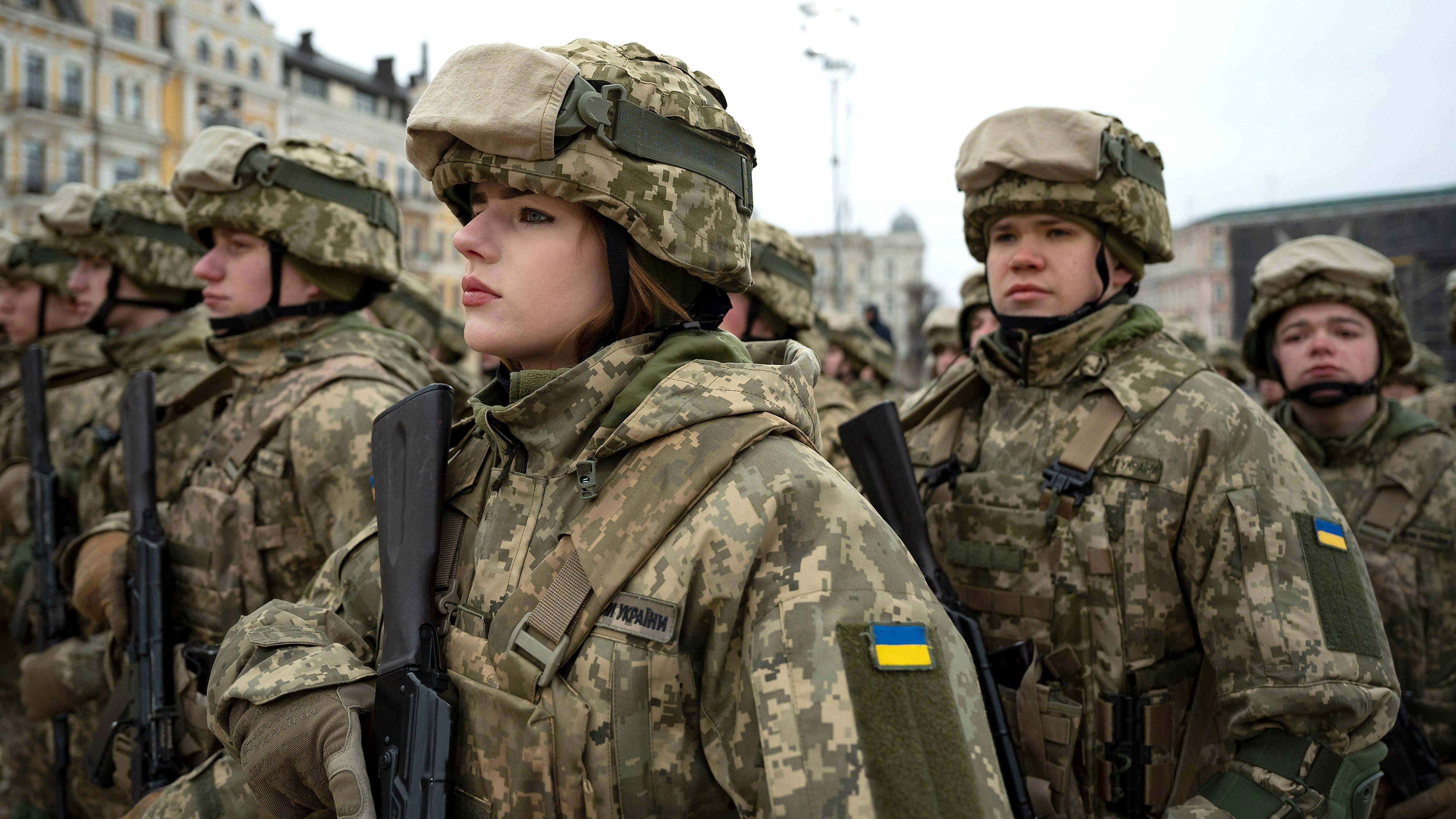 Ukrainian soldiers stand at attention during the 1st anniversary of the Russian invasion