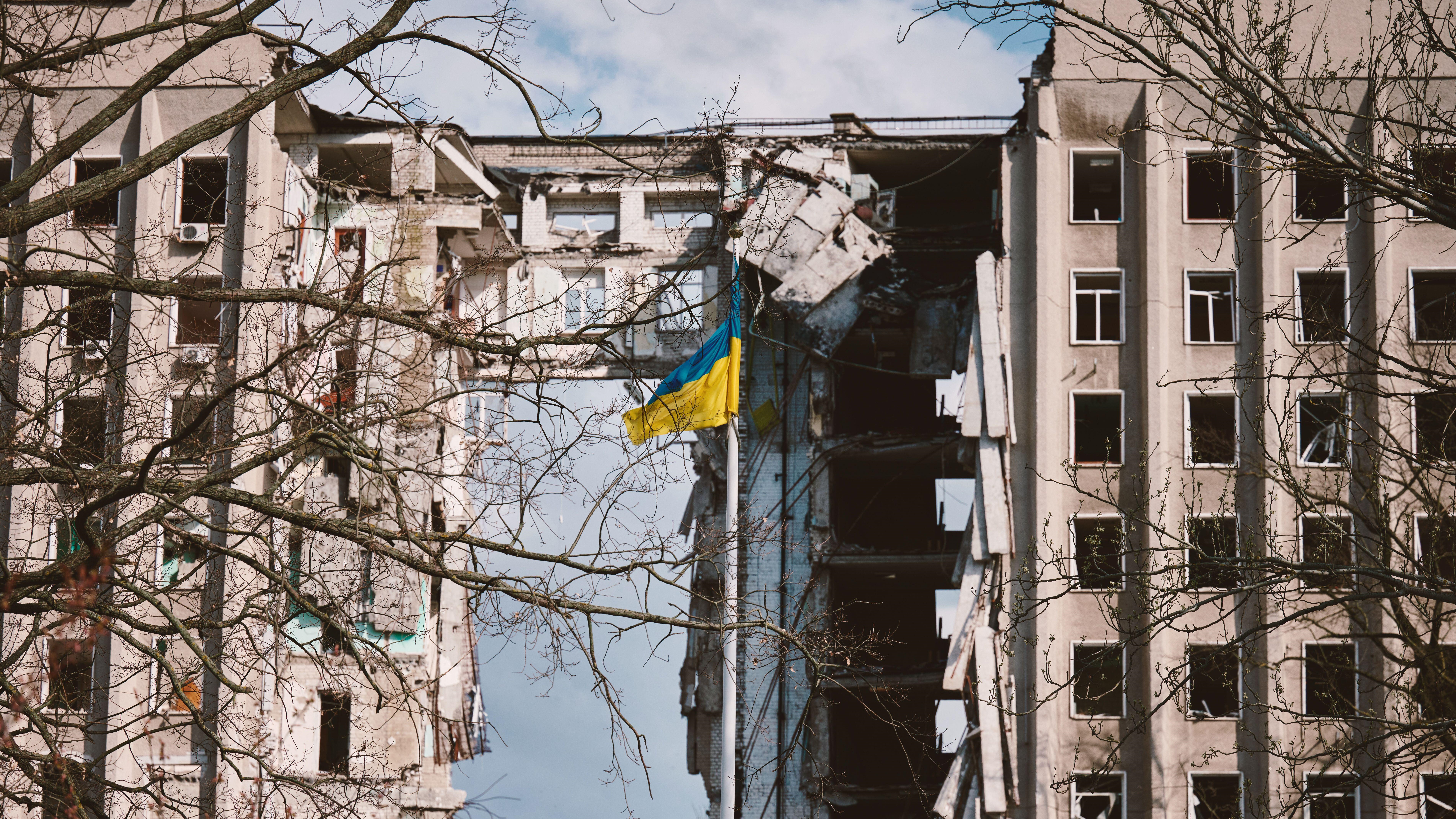 Image ID 2R41RJM Ukraine flag against background of a destroyed building in Ukraine due to Russian air bomb 17042023 CREDIT Alamy EXP 04112023_0.jpg