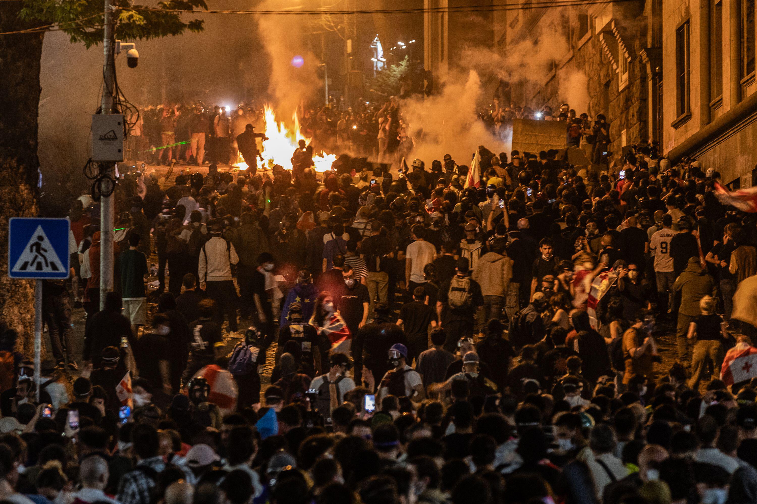 Protestors clash with police during a demonstration outside of the Georgian parliament