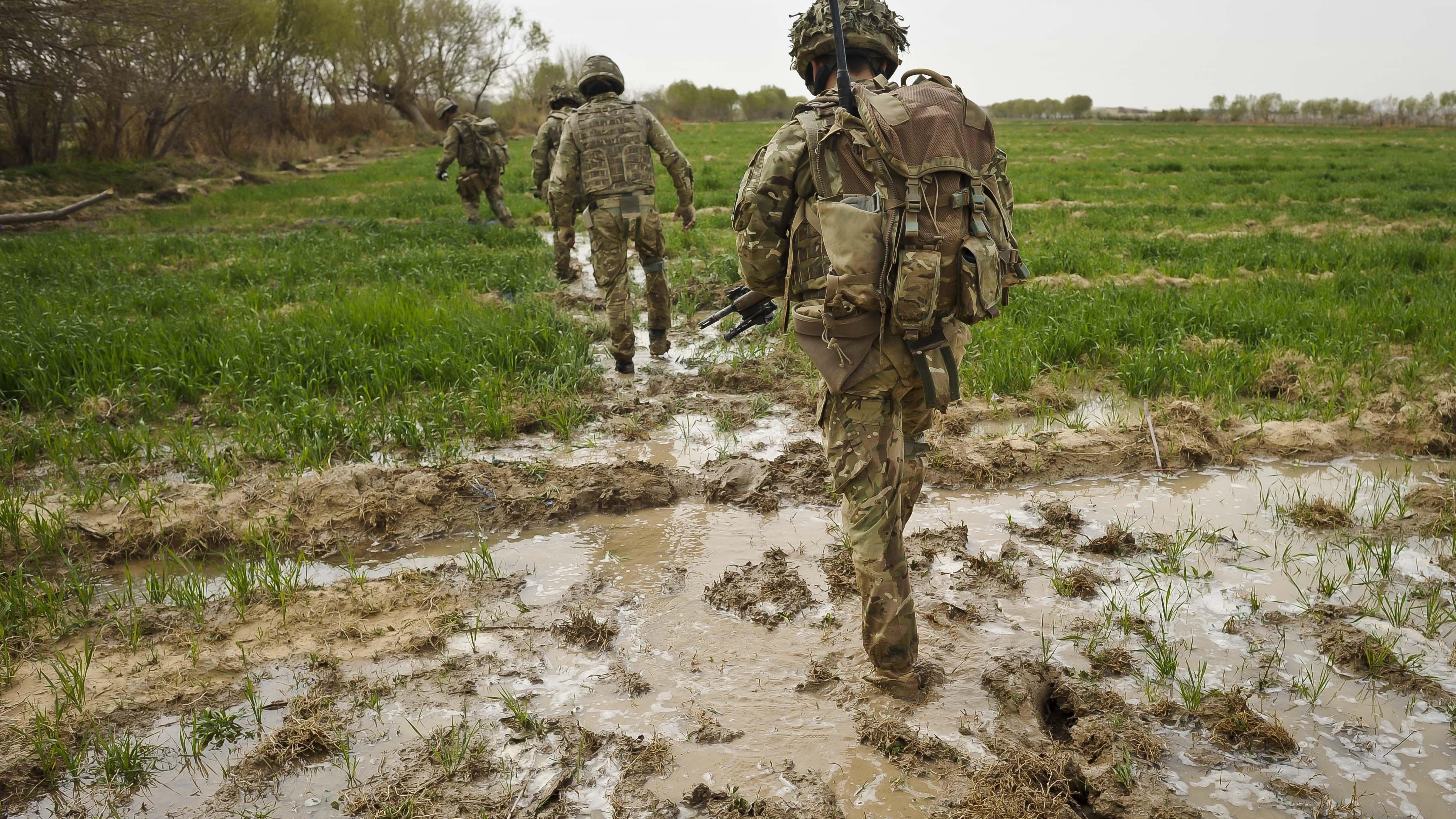 Image ID G521EF ANON Soldiers trudge through flooded field while on patrol in the Deh Adam Khan, Afghanistan 23032012 CREDIT PA Images,Alamy Stock Photo.jpg
