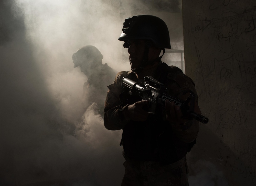 Two members of the counter-terrorist Iraqi Golden Division or Counter Terror Service clear a building during a training exercise