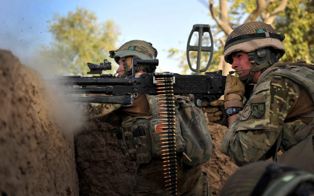 A Ranger from 1 Royal Irish Guards returns fire with his GPMG (General Purpose Machine Gun) after a Taliban ambush on patrol