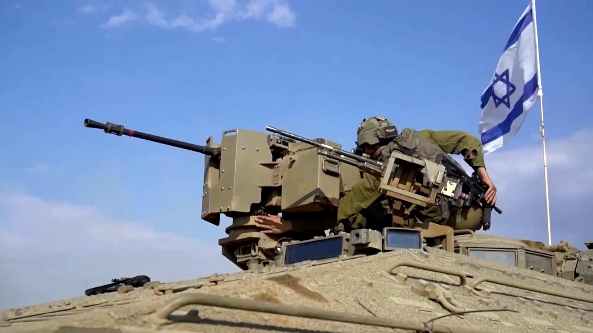 Israeli troops on top of a tank