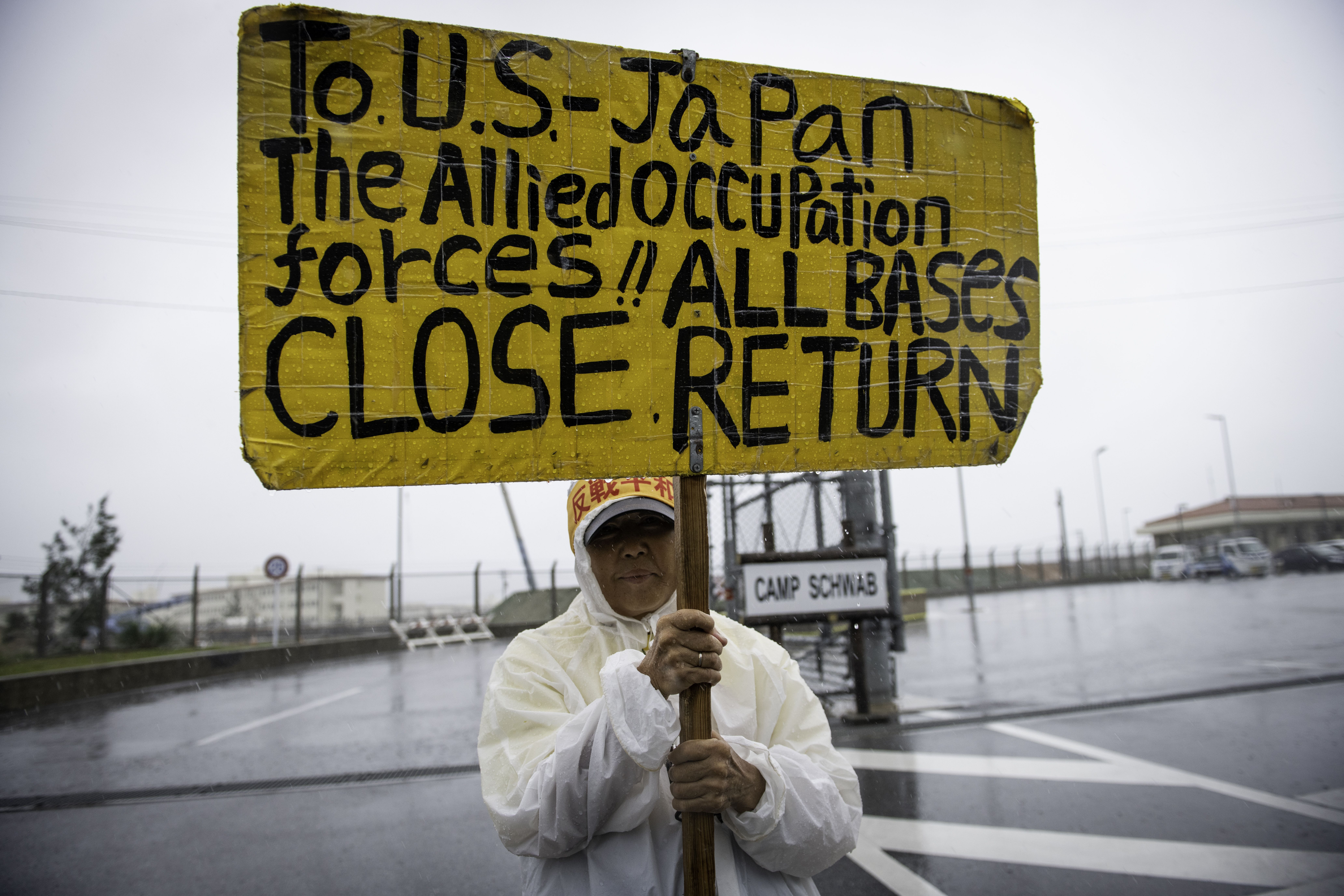 Japanese protester displays sign against a planned U.S military base relocation in Okinawa 