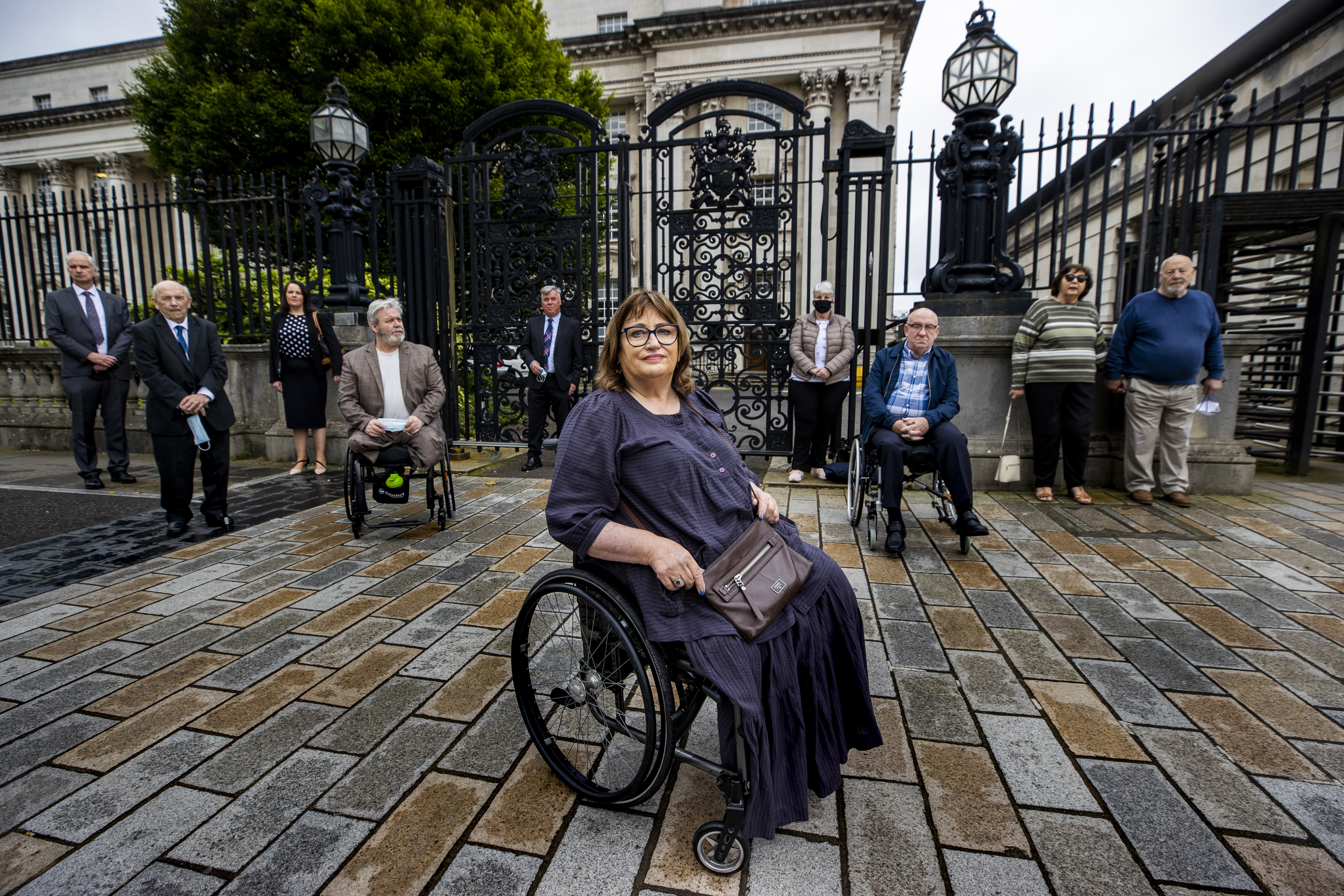 Cover image: Jennifer McNern (centre), joined by legal team and members of the Wave Trauma group outside Belfast High Court (Picture: PA).