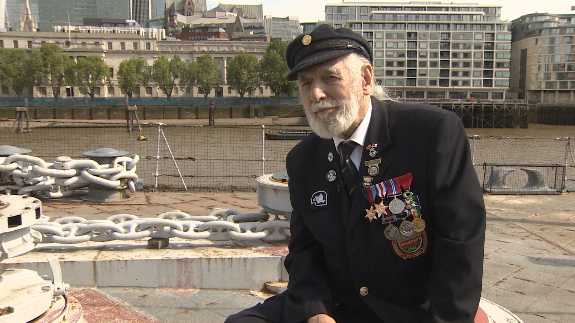 Jim Radford sitting on HMS Belfast.