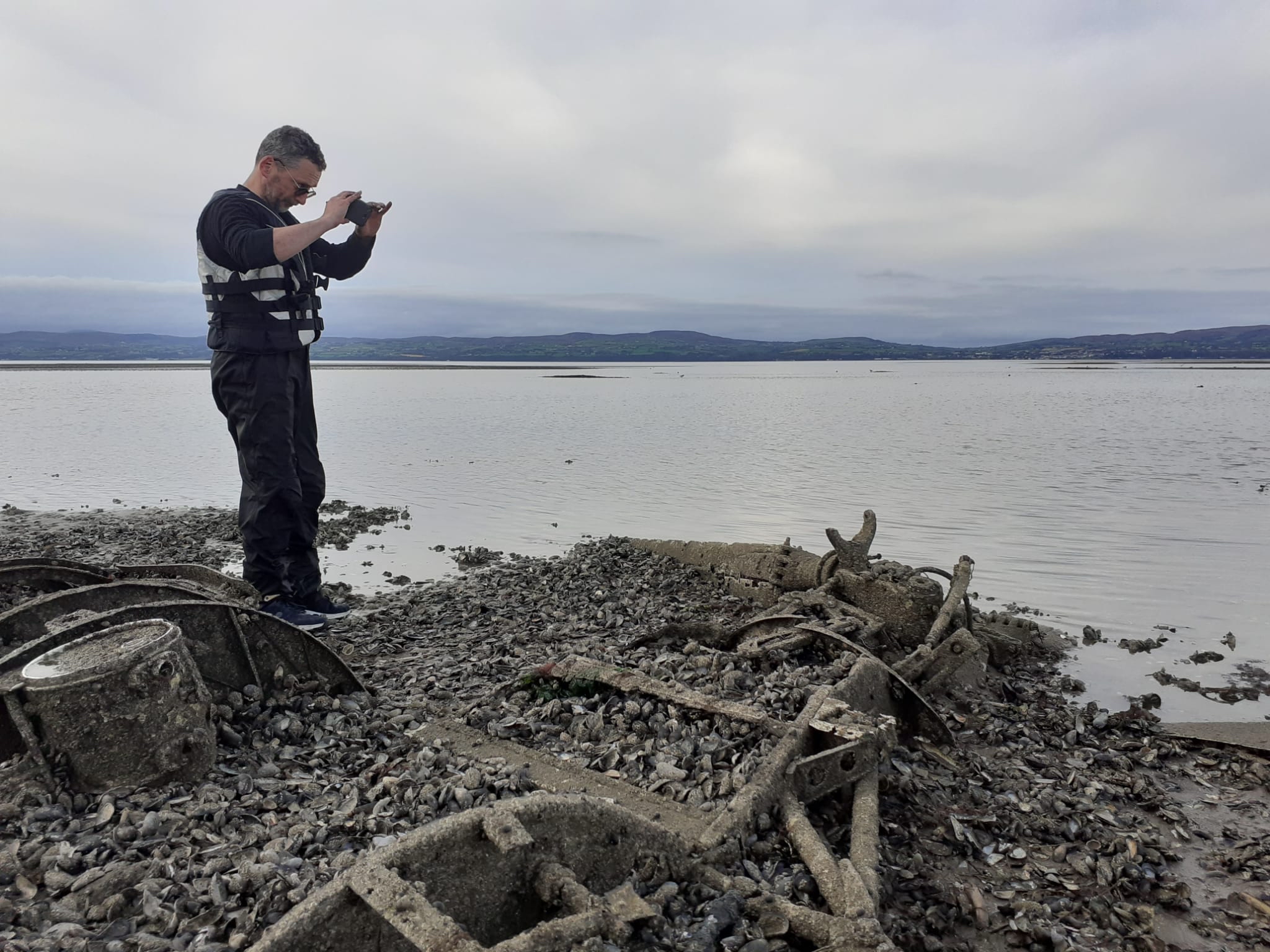Jonny McNee, DAERA Marine Plan team, photographing the rotor and rotor blades of the discovered Royal Navy Dragonfly helicopter (Picture: DAERA) 