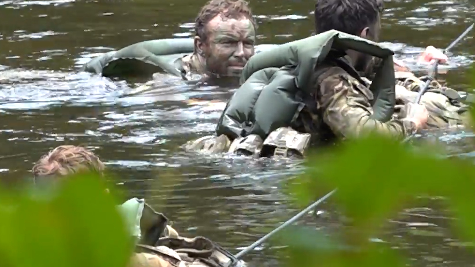 Soldiers from the 1st Battalion Royal Anglian Regiment crossing the Macal River