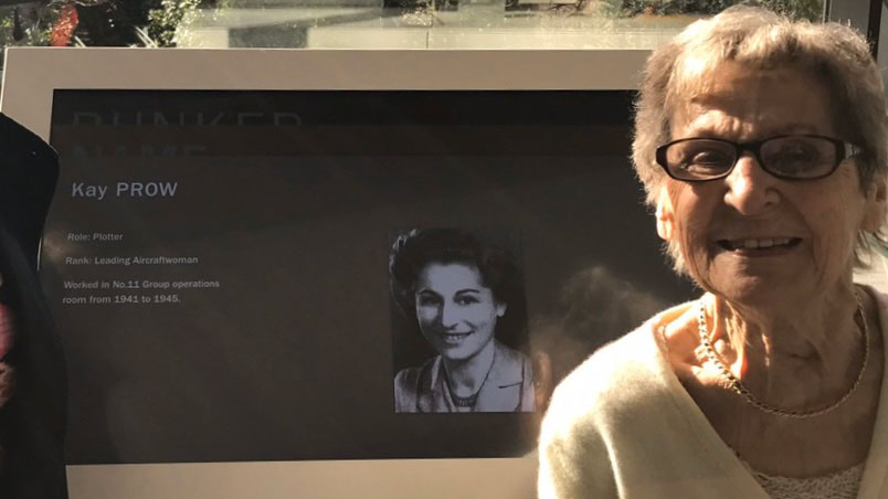 Mrs Thomas pictured beside an information slide about herself at the Battle of Britain bunker (Picture: Royal Star & Garter)