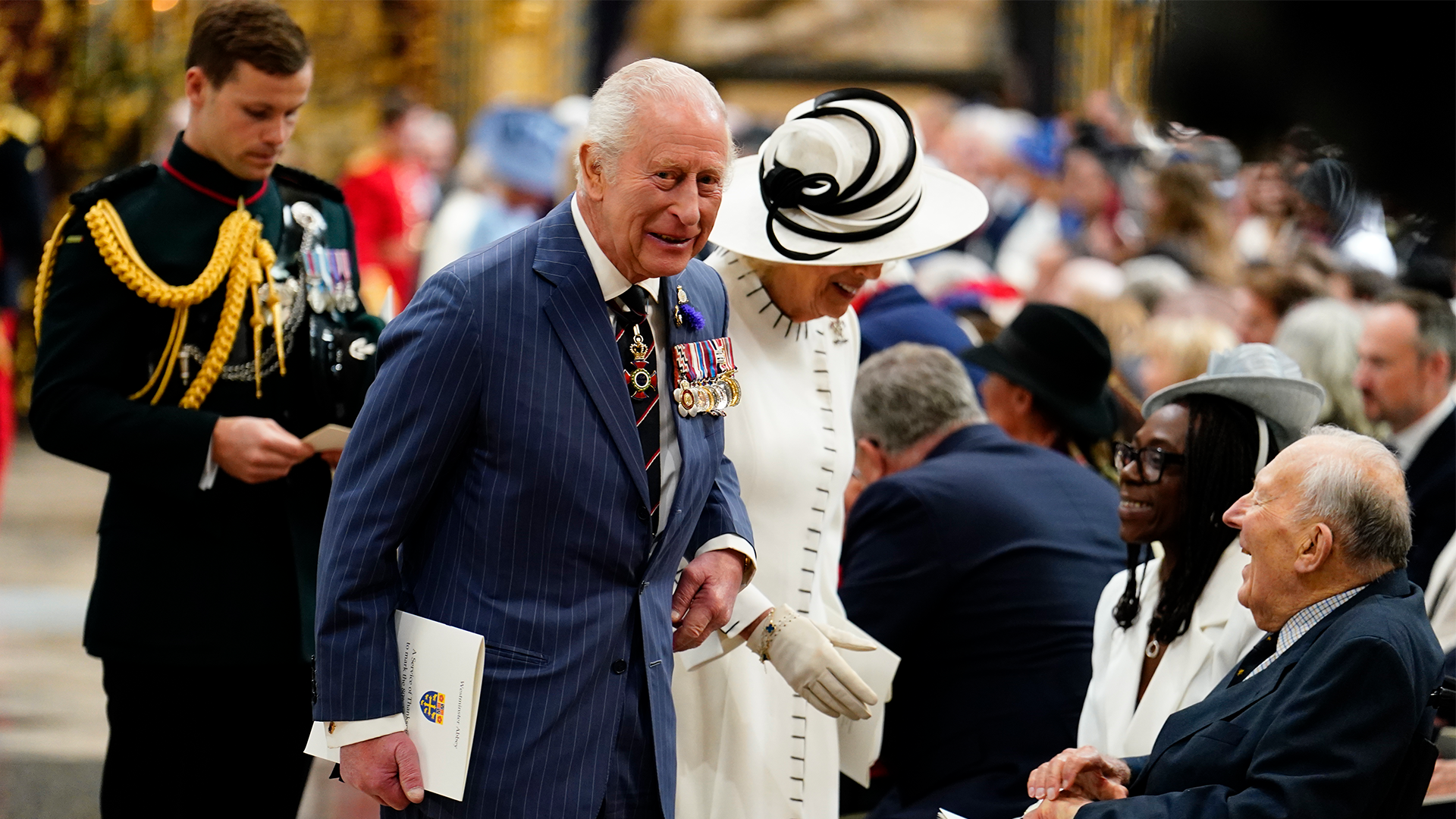 King Charles III and Queen Camilla speak with Second World War veterans and guest following a service of thanksgiving at Westminster Abbey