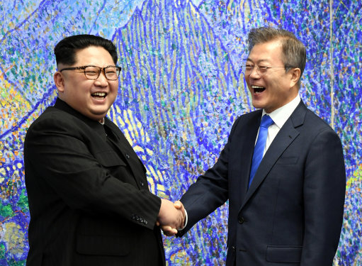 The Korean leaders shake hands inside the Peace House (Image: PA).