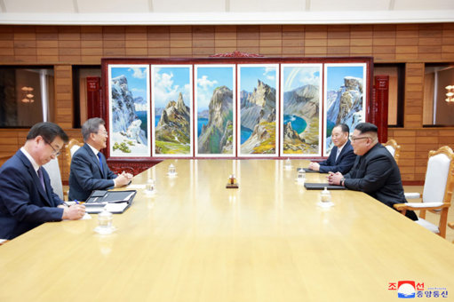 The two Korean leaders discuss at their latest meeting (Picture: KNCA/PA).