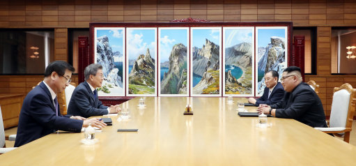 The two Korean leaders discuss at their latest meeting (Picture: PA).