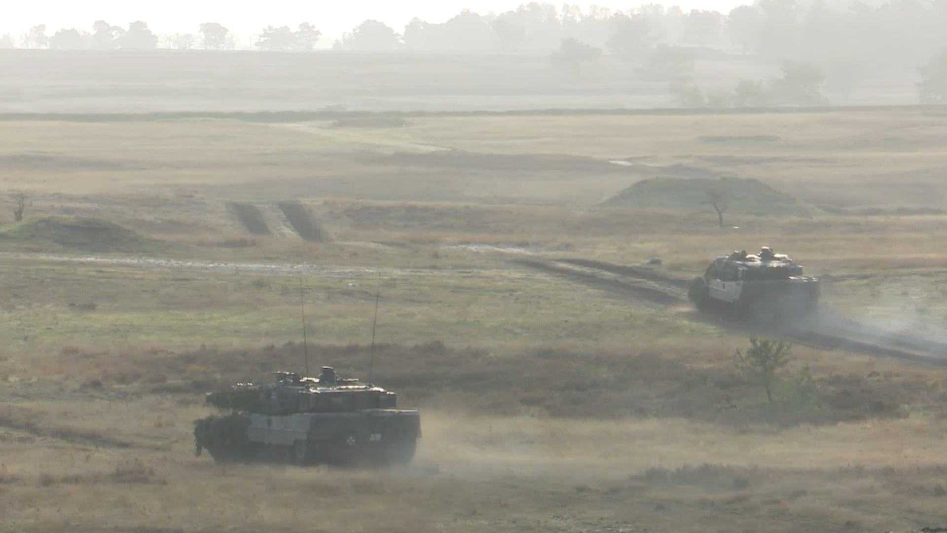 Leopard 2 tanks demonstrating capabilities cross-terrain.