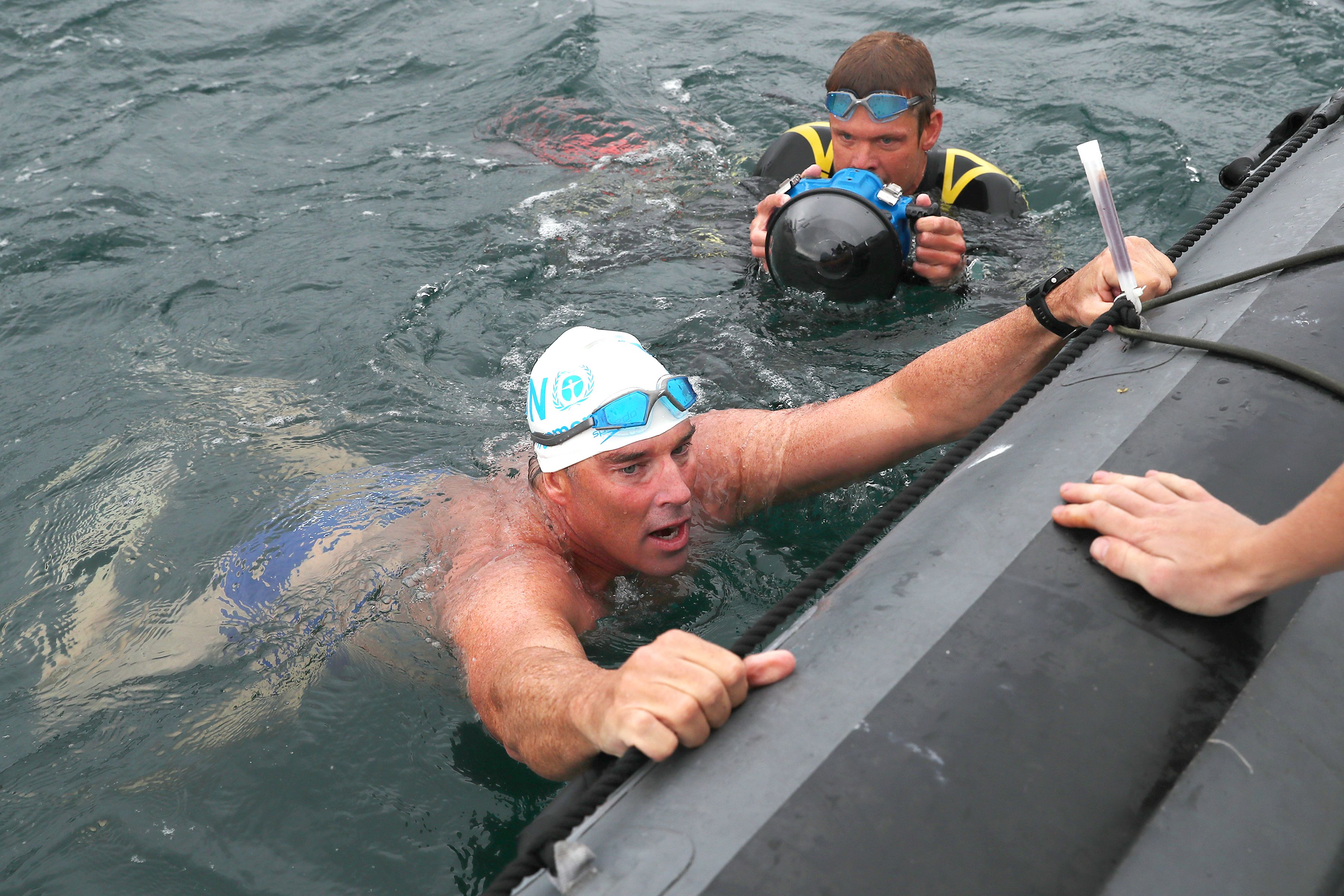 Lewis Pugh prepares to be taken to HMS Hurworth  (Credit: Royal Navy)