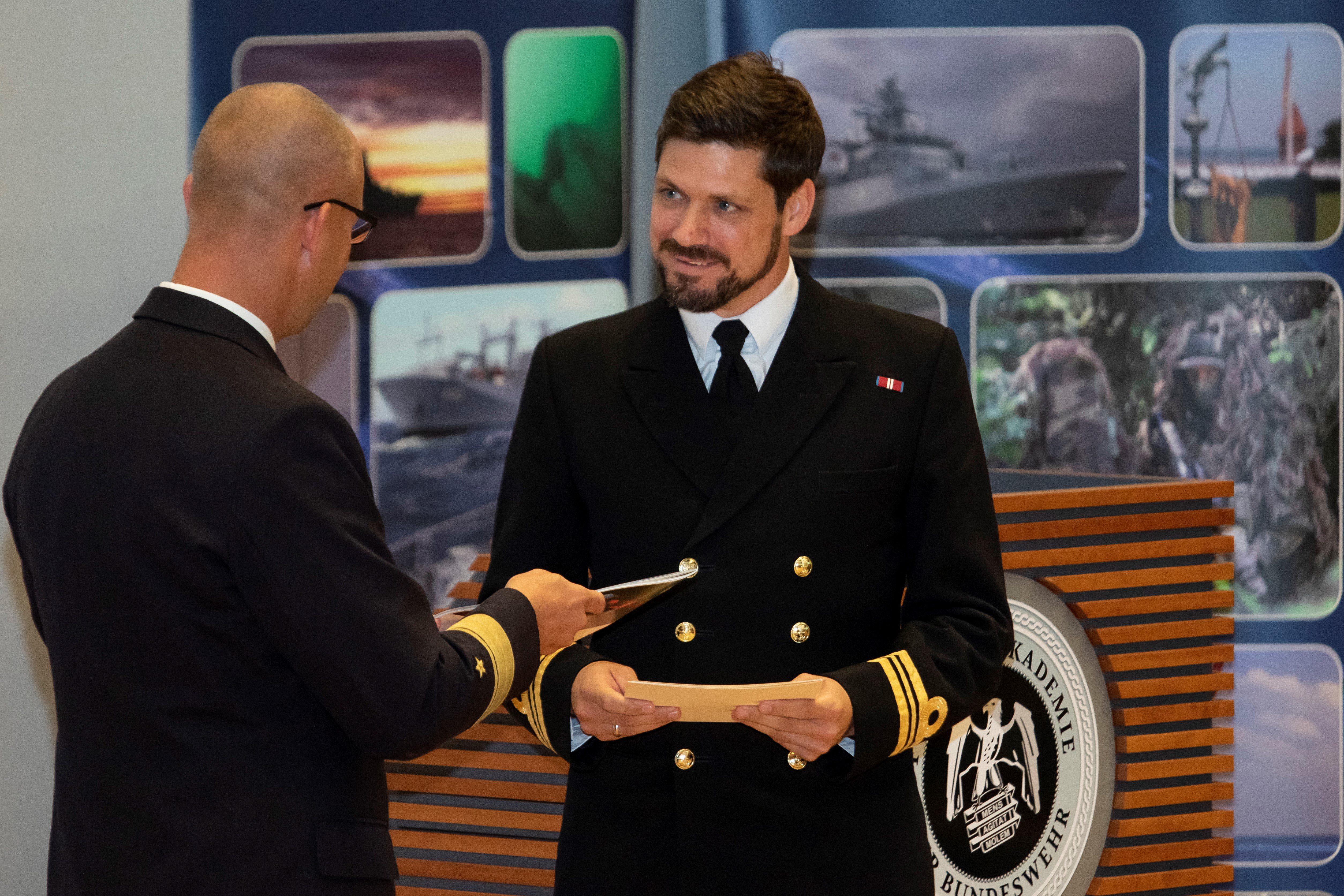 Cover image: Lieutenant Commander David Roberts (right) receives the top naval student award from the Commander of the German Navy's Baltic Forces (Picture: Royal Navy).
