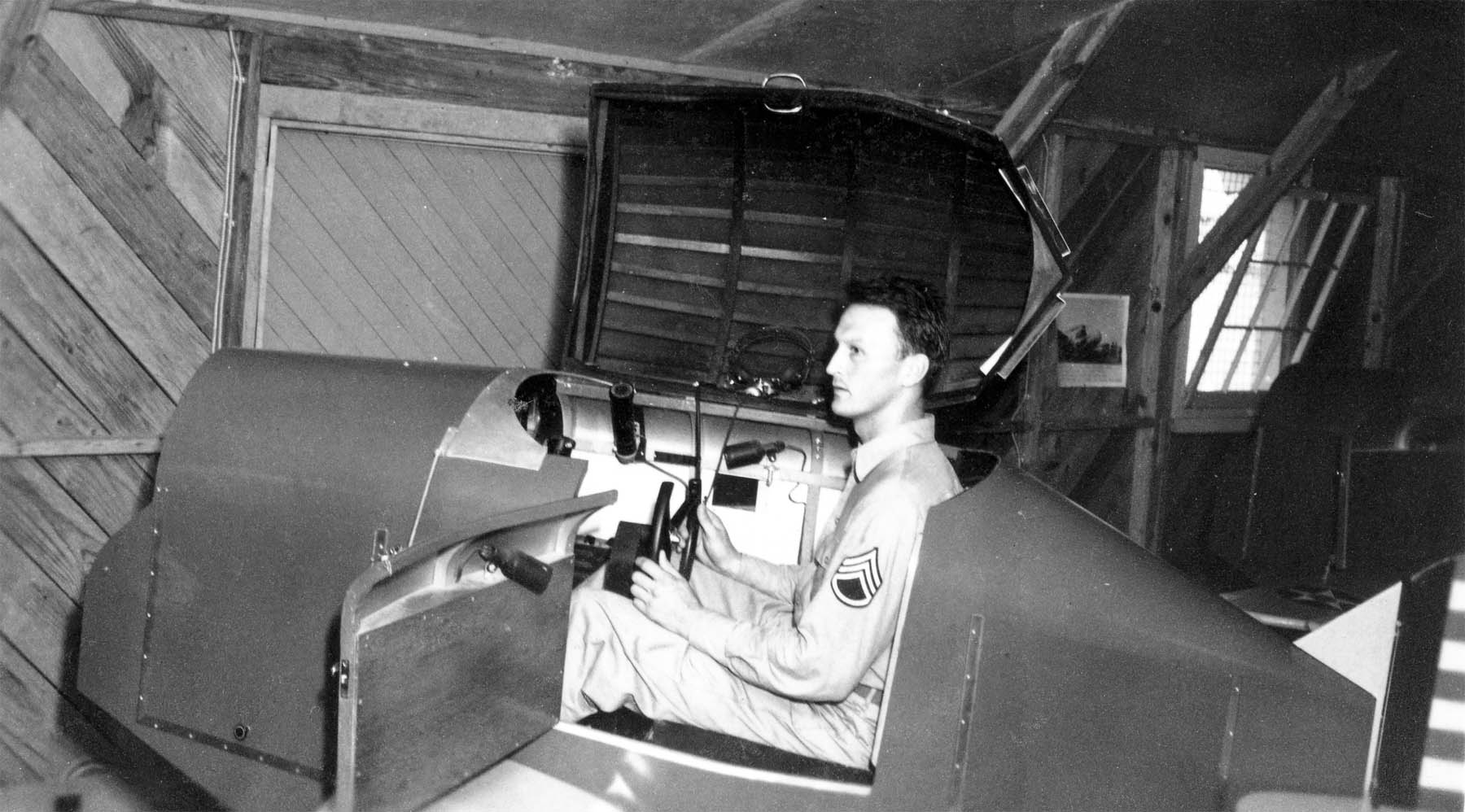TSgt James R Schneid on a Link trainer - CREDIT: Historic Wings Magazine