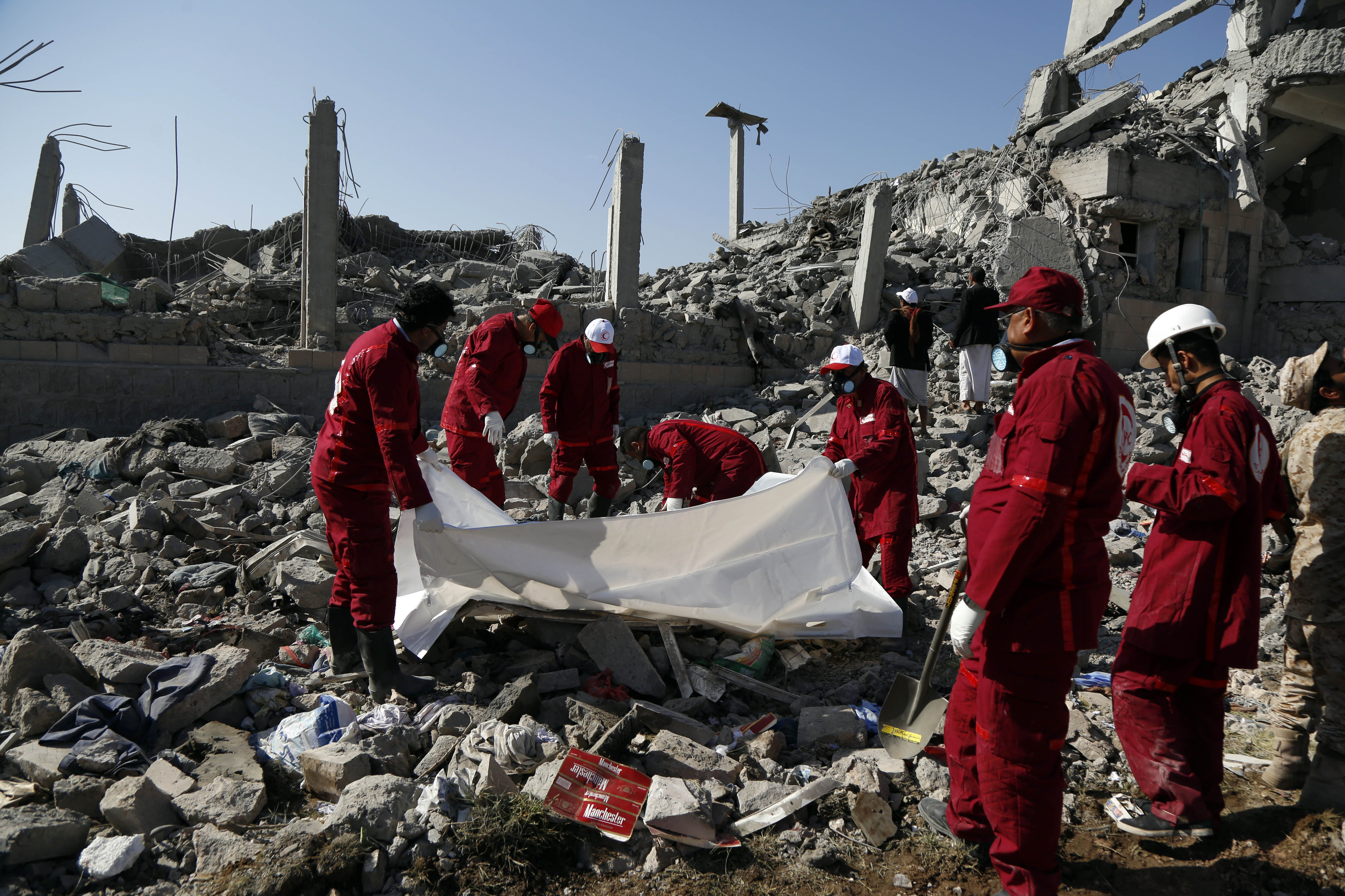 Local Red Crescent medics carry the body of a victim following the air strikes (Picture: PA).