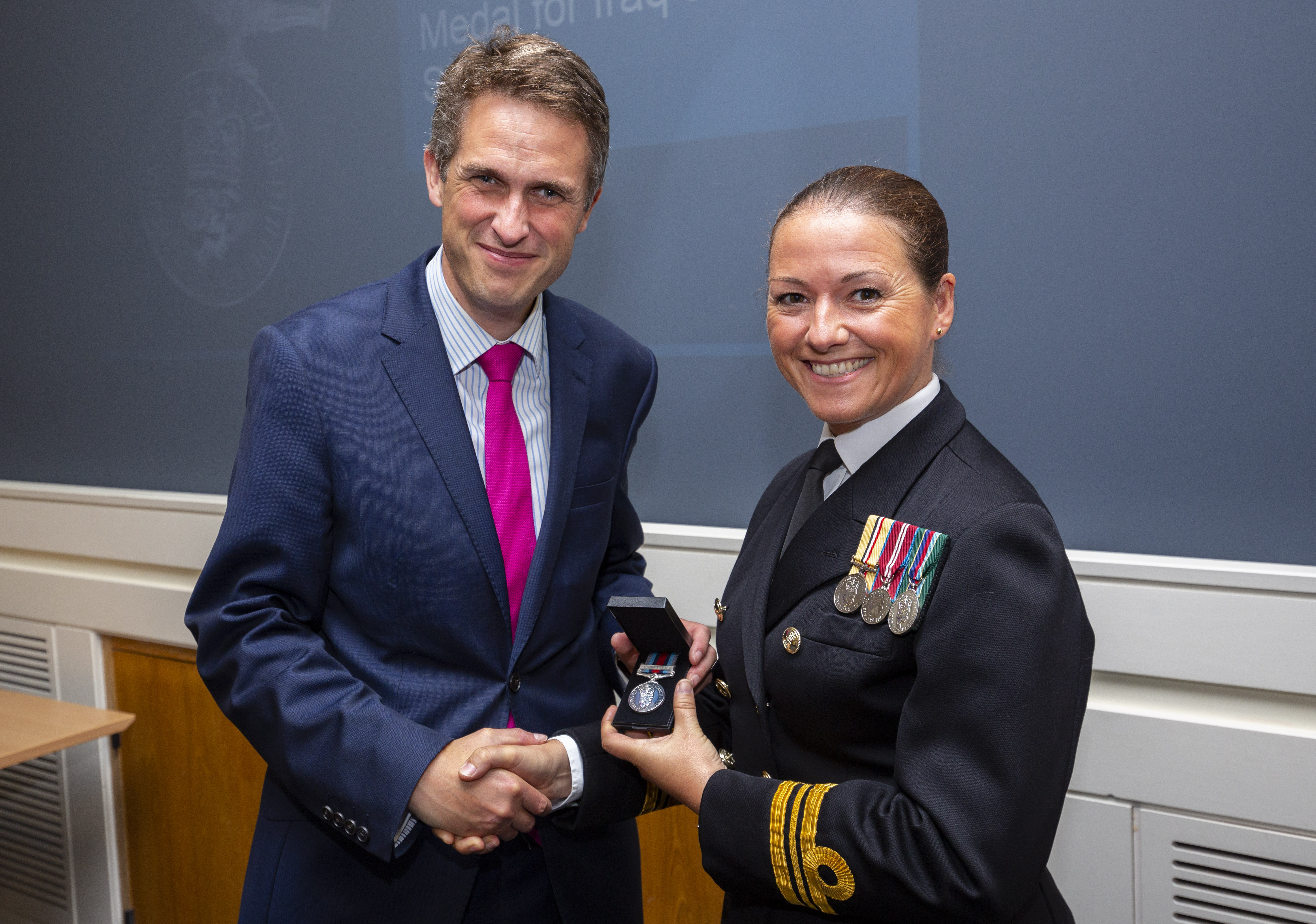 Lt Cdr Lindsey Waudby (right) with the Secretary of State for Defence, Gavin Williamson (left) after being presented with her new Operational Service Medal at a ceremony at the Ministry of Defence building in London today 