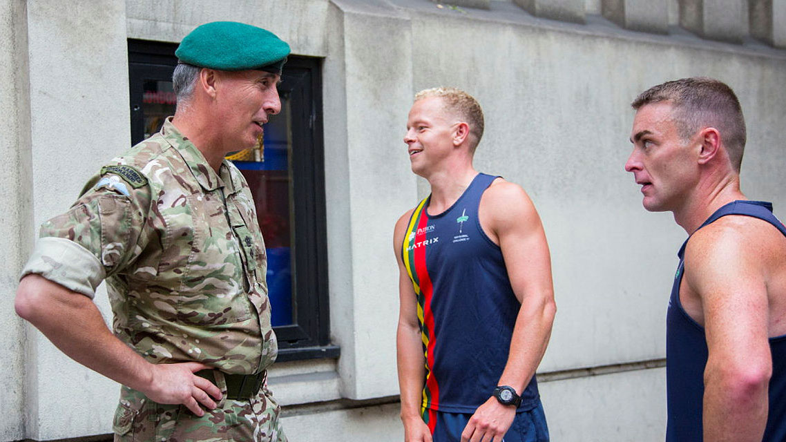 Lt Col Gary Green from Commando Training Centre RM congratulates two runners from the 1664 Global Challenge 2 August 2017 CREDIT Crown Copyright