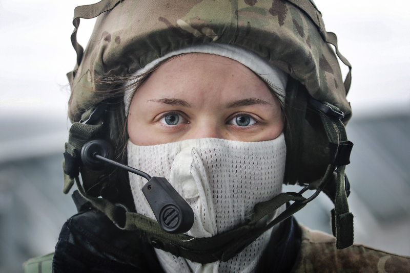 a female sailor onboard HMS Albion, taking part in a simulated attack exercise.