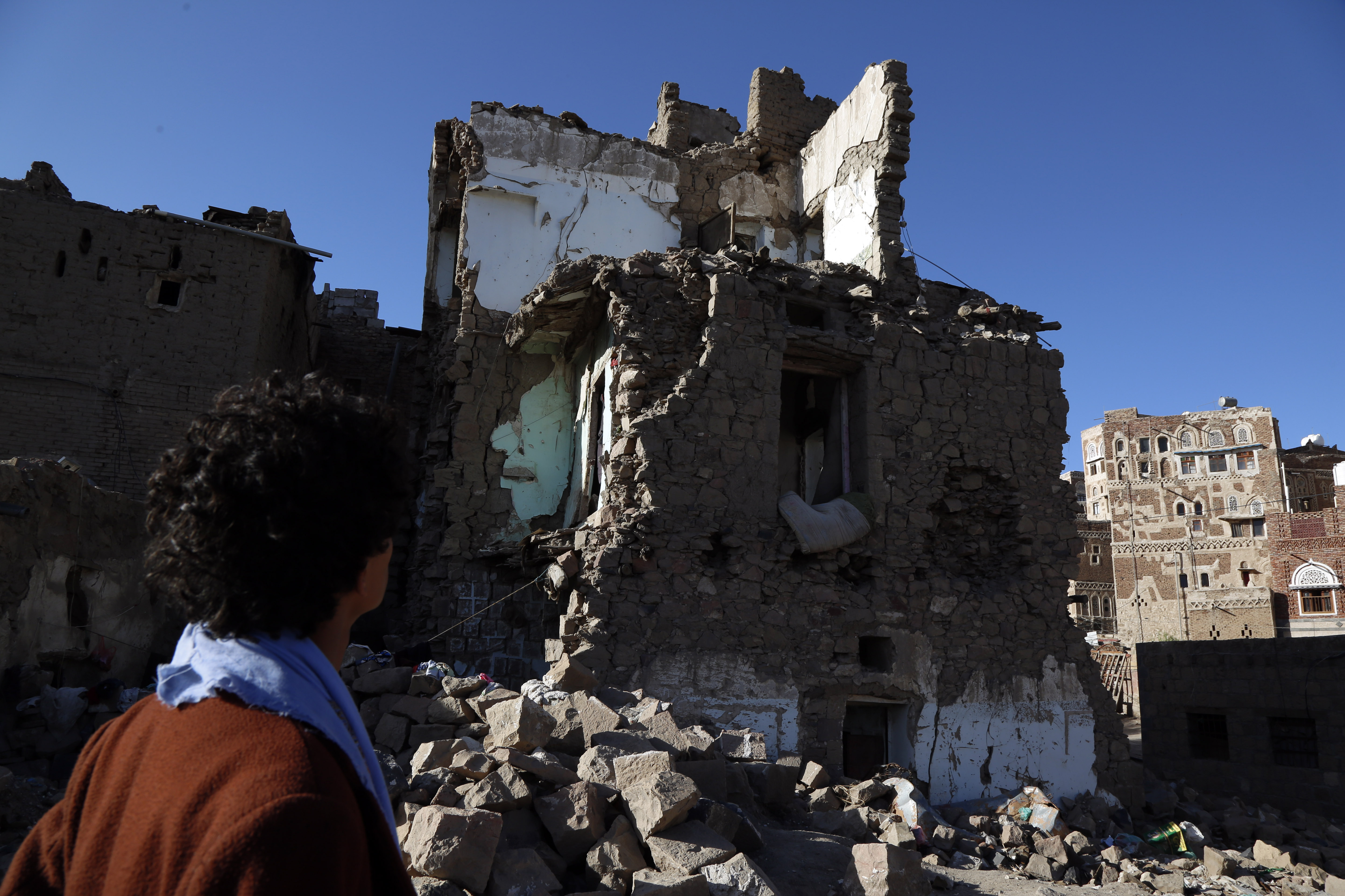 Man looks at a house destroyed in an airstrike in Sanaa, Yemen 090420 CREDIT PA Xinhua News Agency