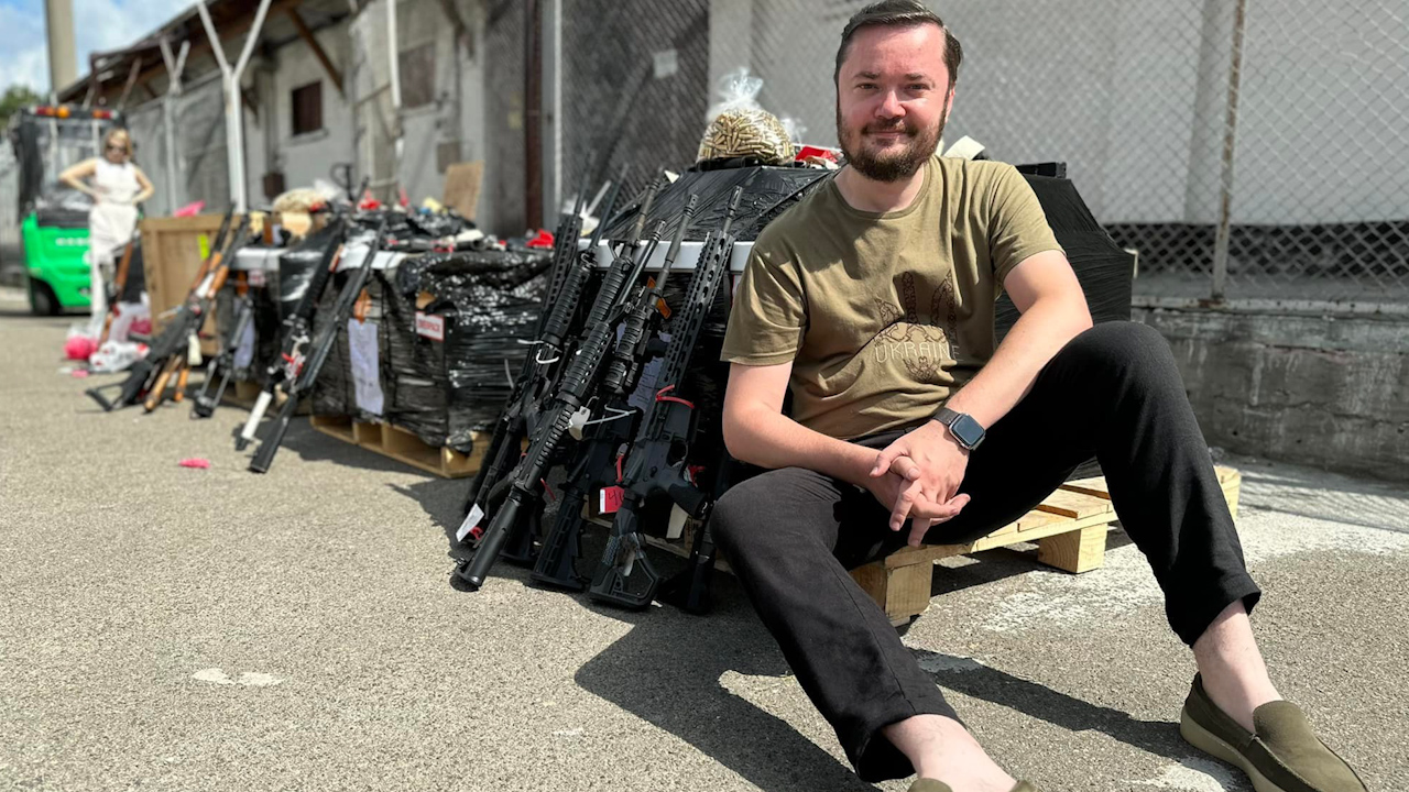 Ukrainian MP Maryan Zablotskiy pictured with the weapons donated by Miami Police Department (Picture: Maryan Zablotskiy Facebook). 