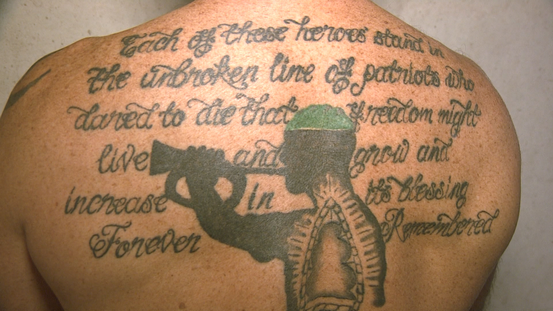 Matt Tomlinson's tattoo of a Royal Marines Bulger playing the last post 140919 CREDIT BFBS.jpg