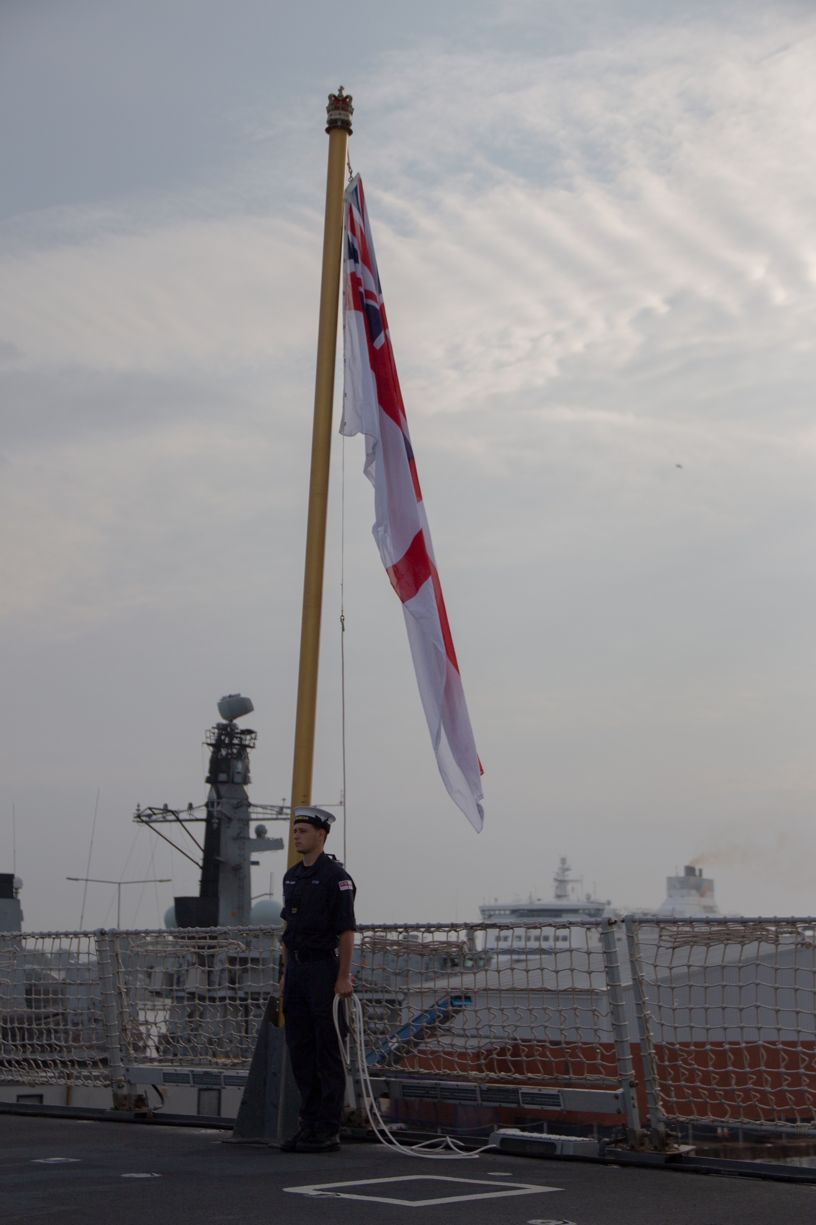 Member of HMS Duncan's crew returning to the ship after the completion of the vessel's 18-month refit