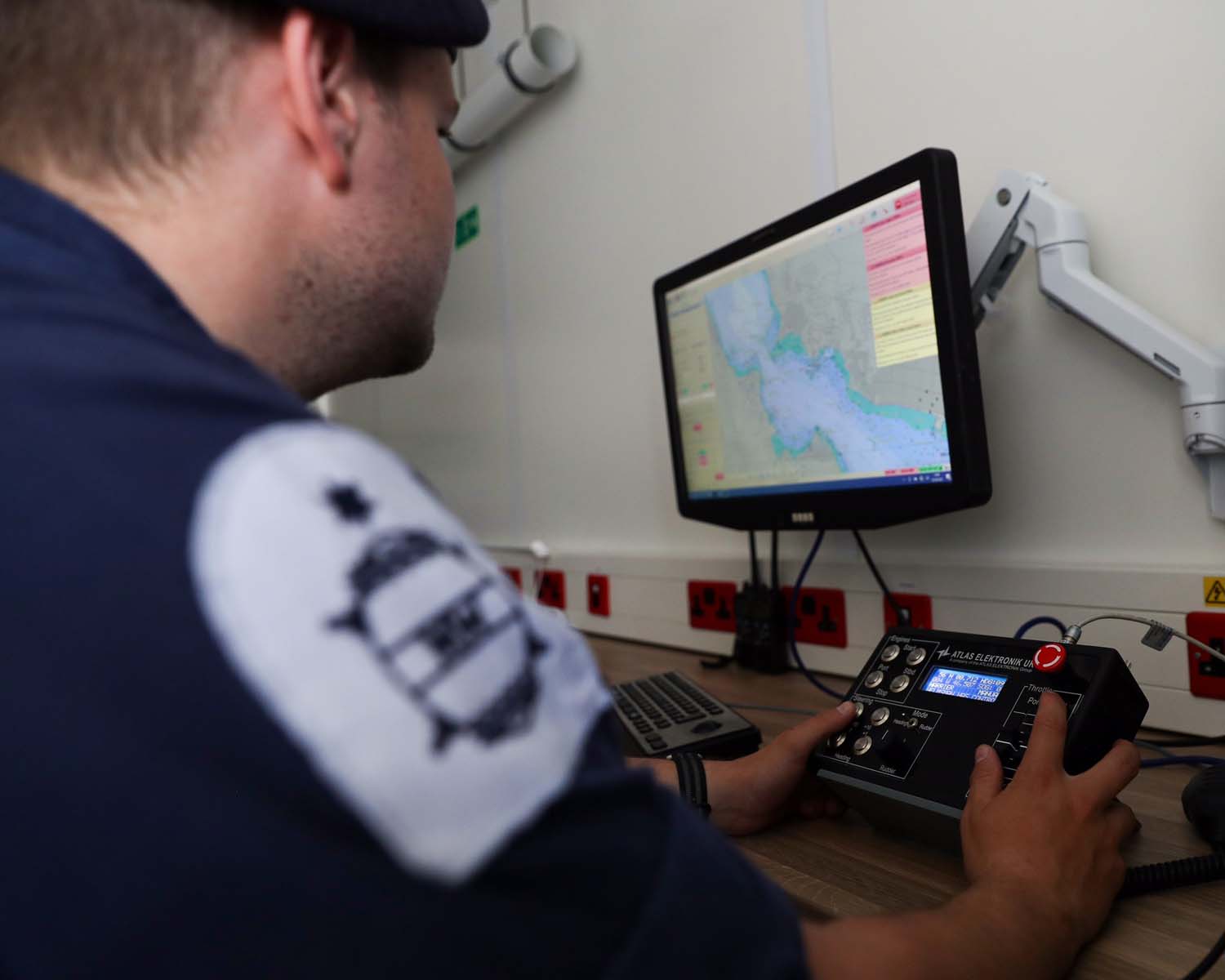 Member of the Royal Navy controlling the autonomous minehunting vessel, a result of Project Wilton 