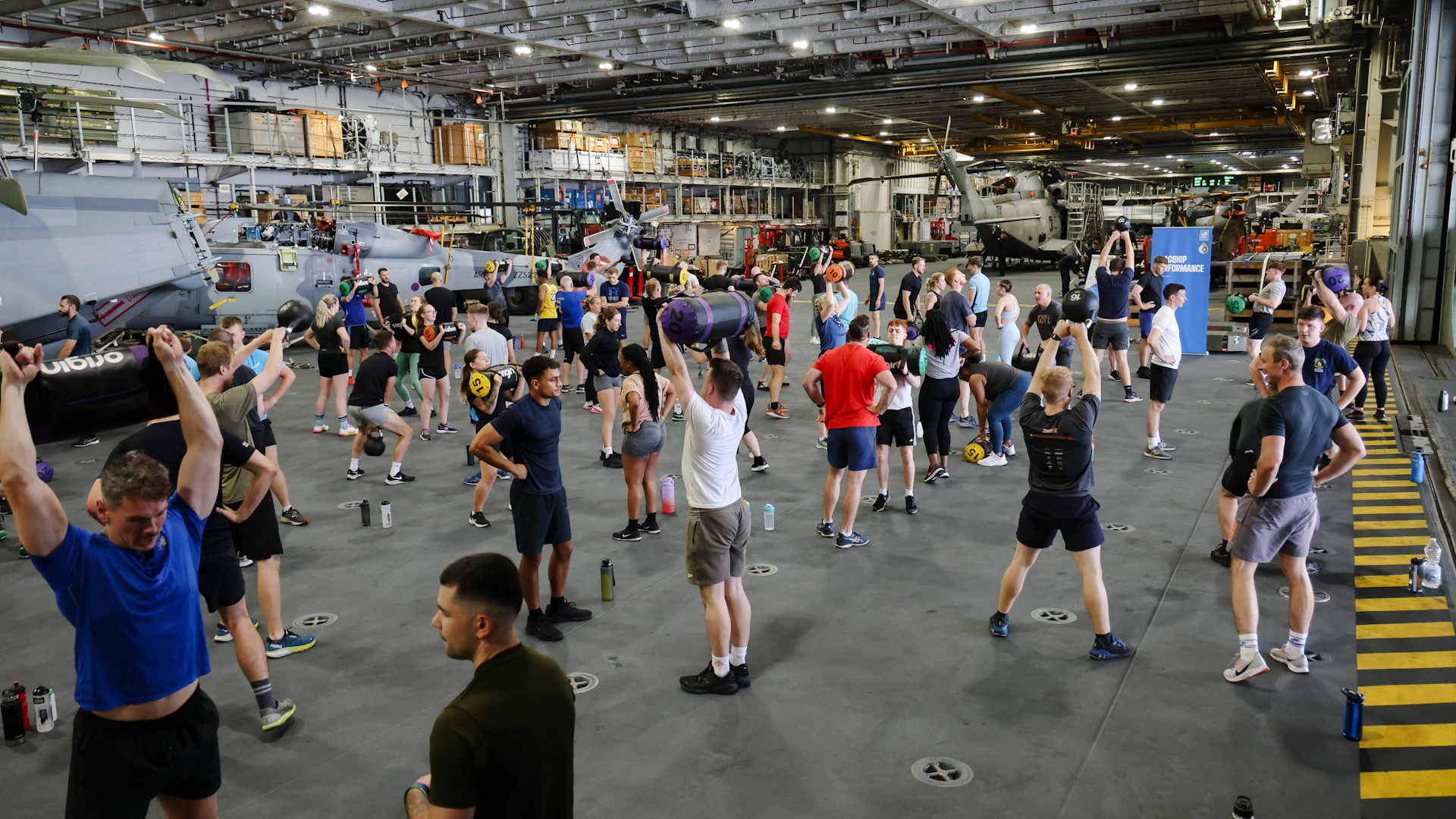 Members of HMS Queen Elizabeth's crew taking part in fitness initiative onboard the ship