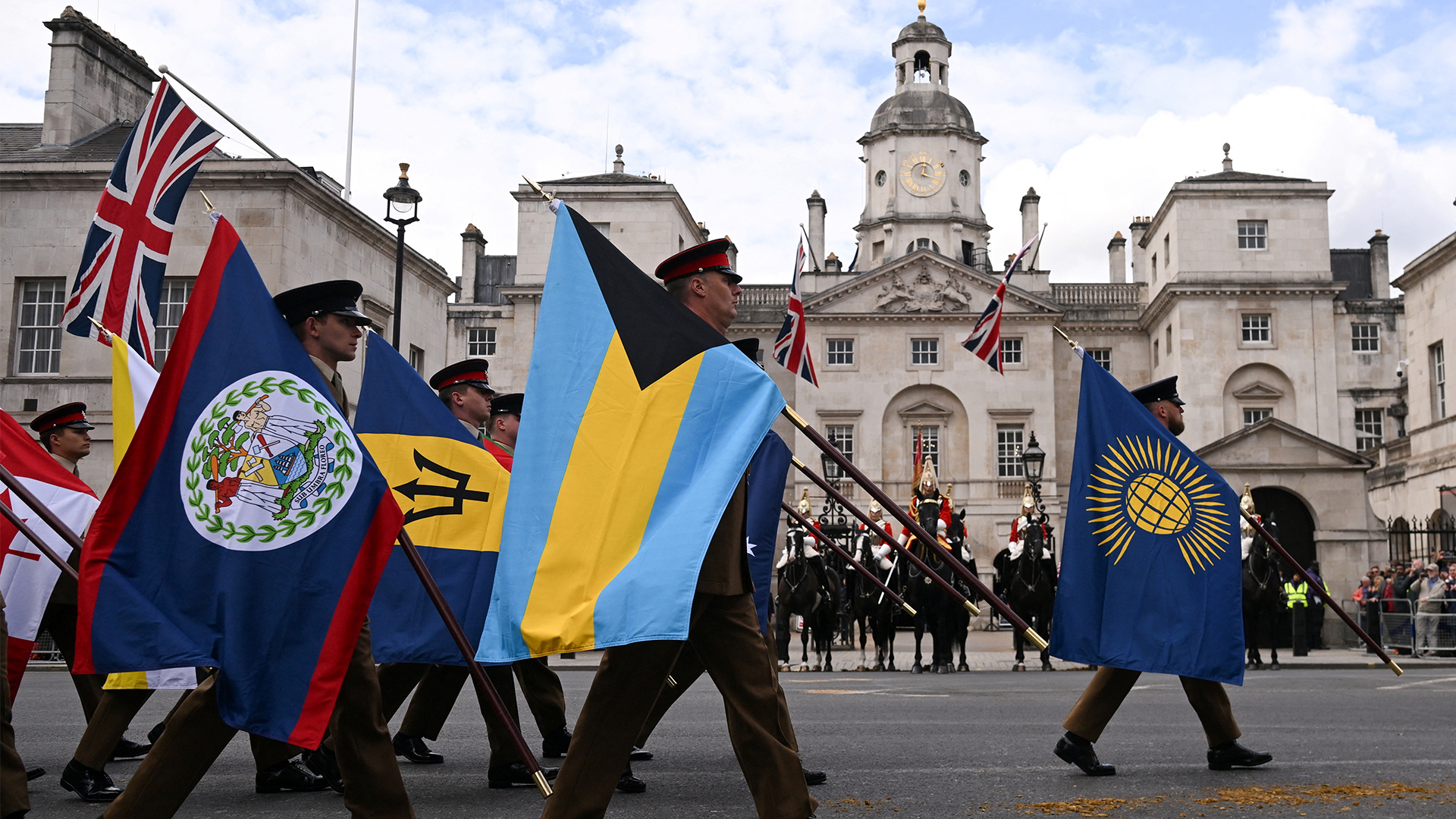 Members of the Colour Party carry flags of the Commonwealth and Allied nations as they march along Whitehall