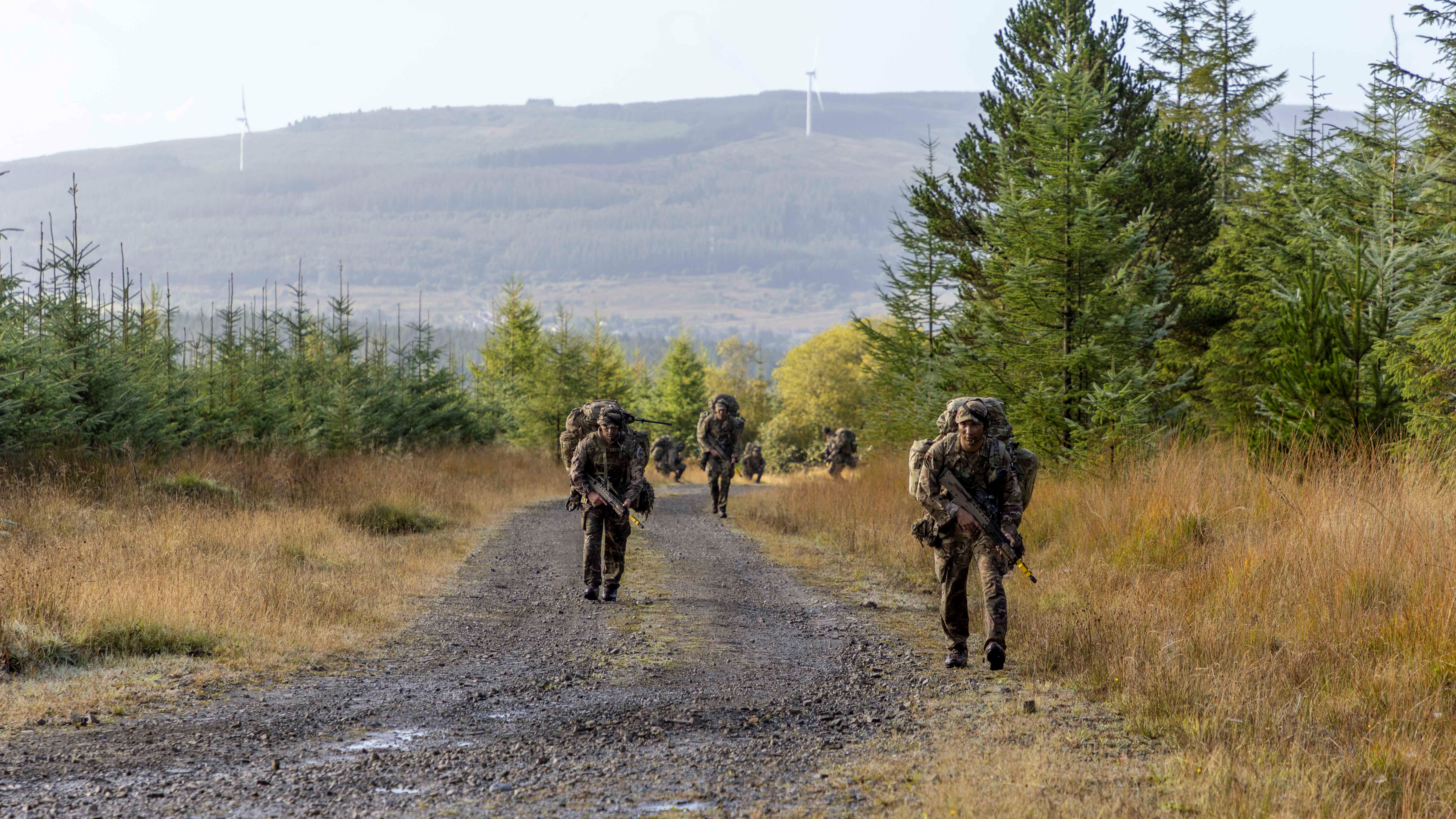 Members of the Rifles Regiment patrolling along a track on Exercise Cambrian Patrol 13102022 CREDIT Army, MOD