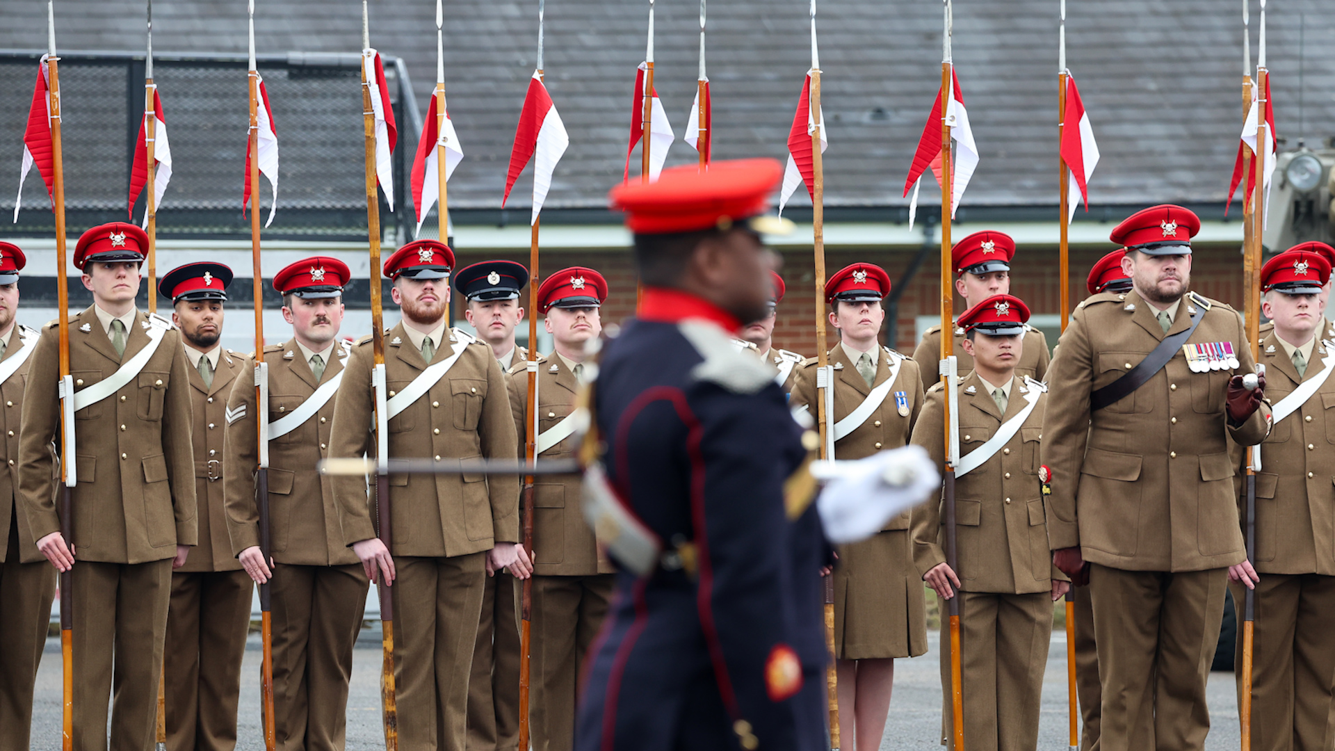 Members of the Royal Lancers standing to attention ahead of a visit by Queen Camilla to the Royal Lancers regiment
