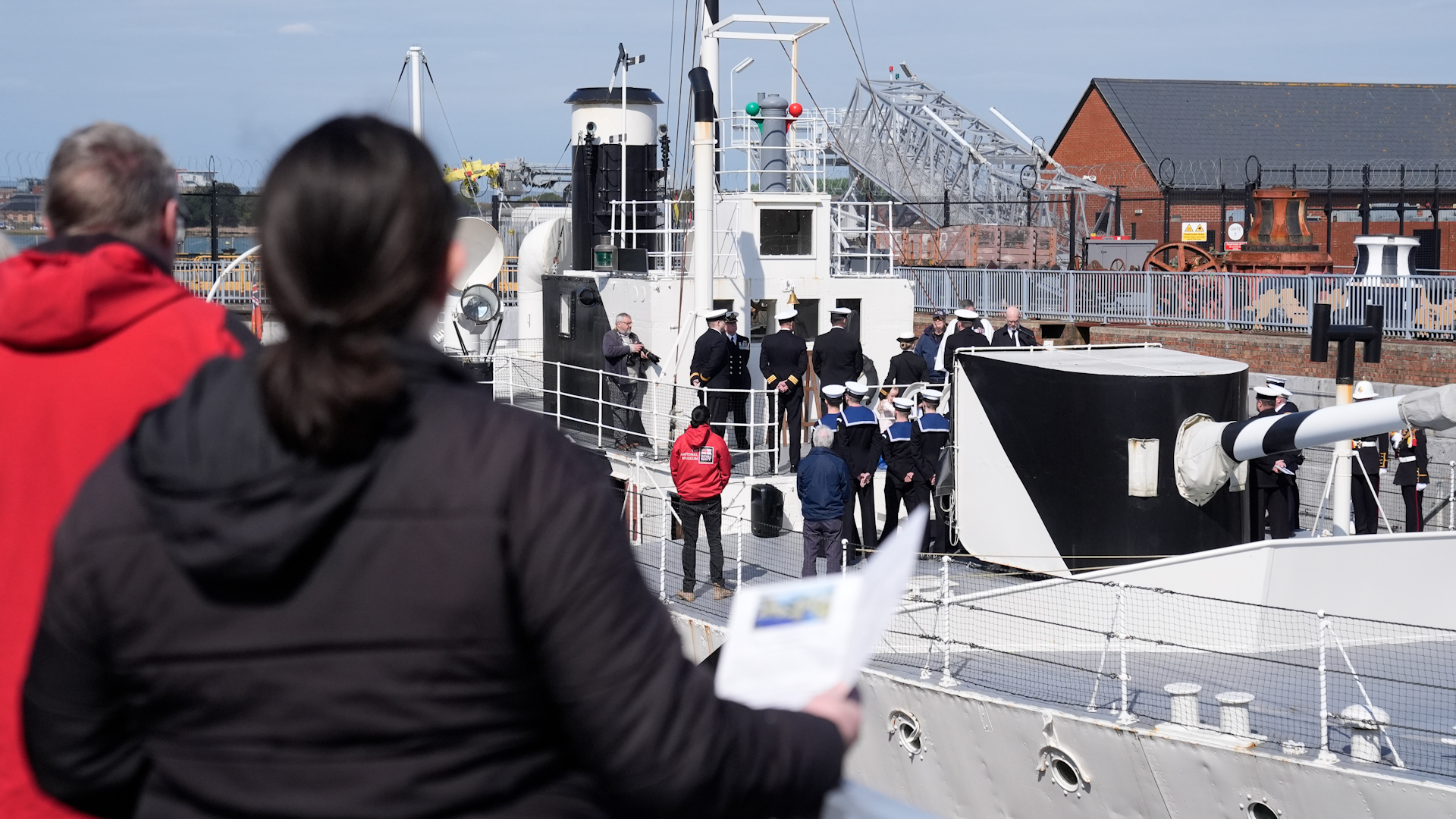 Members of the Royal Navy, Royal New Zealand Navy and Royal Australian Navy take part in an Anzac Day service of remembrance on board HMS M.33, the sole-surviving ship from the Gallipoli campaign