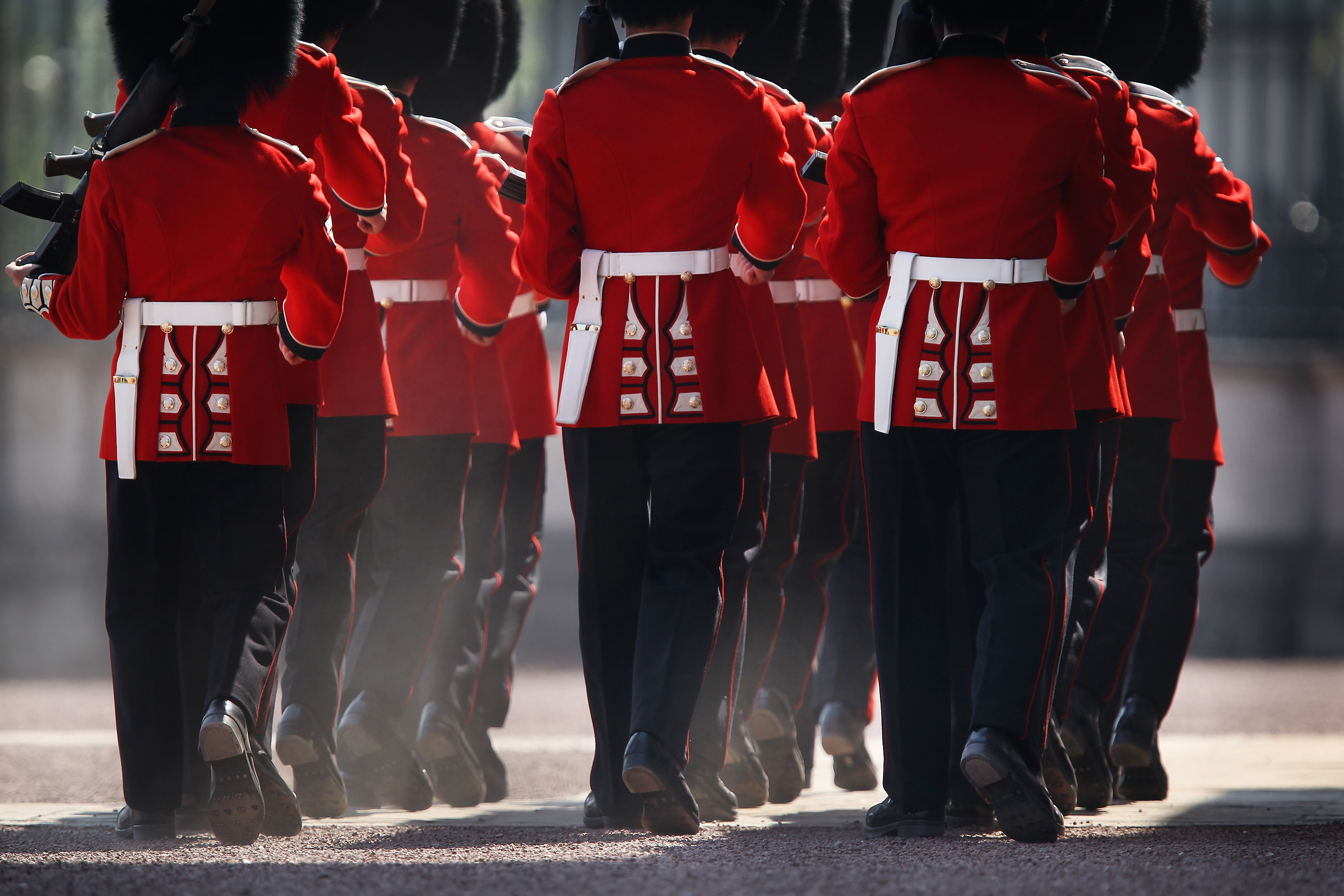 Members of the Scots Guards kick up dust during the Changing of the Guard ceremony at Buckingham Palace in London